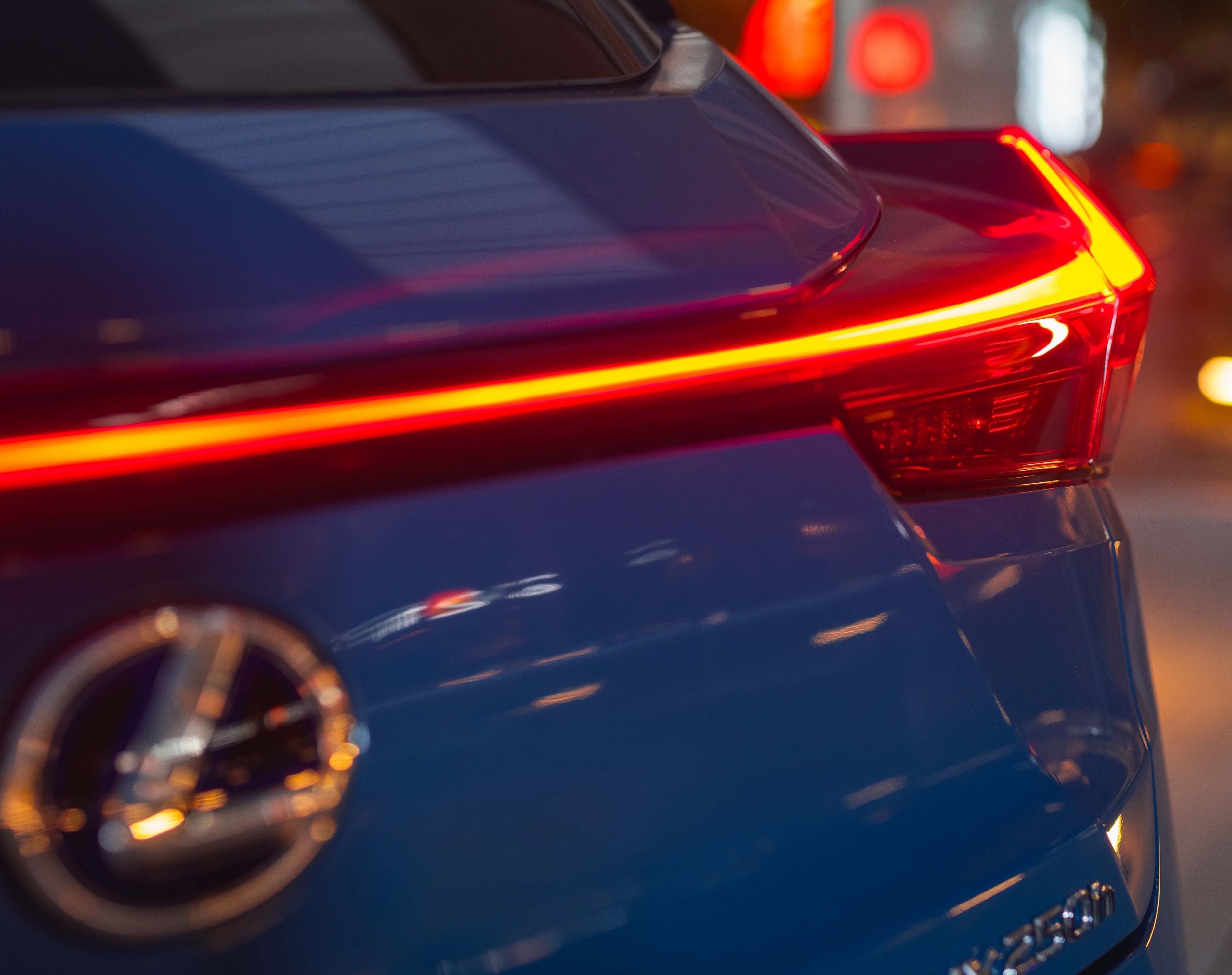 2019 Lexus UX 250h Limited, Celestial Blue, rear tail light night shot, International image shown