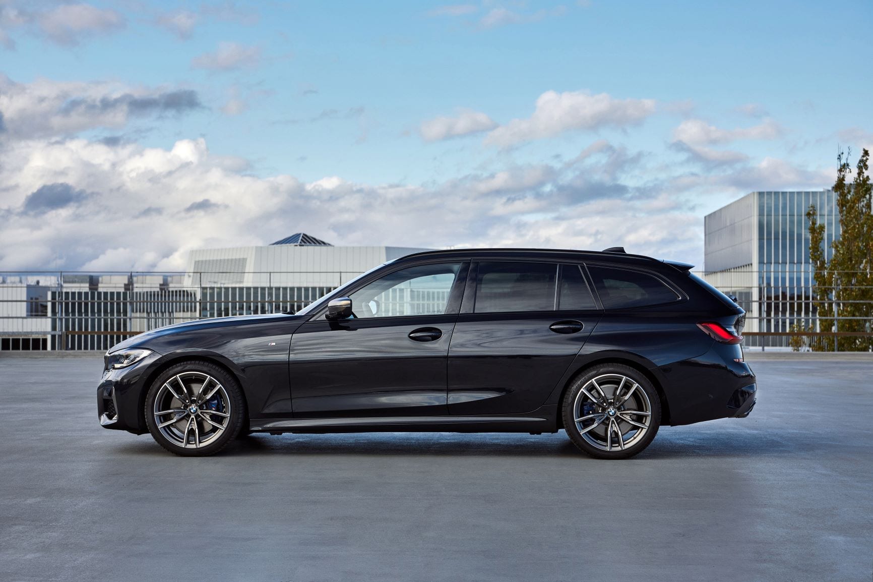 Side profile of a black BMW M340i Touring