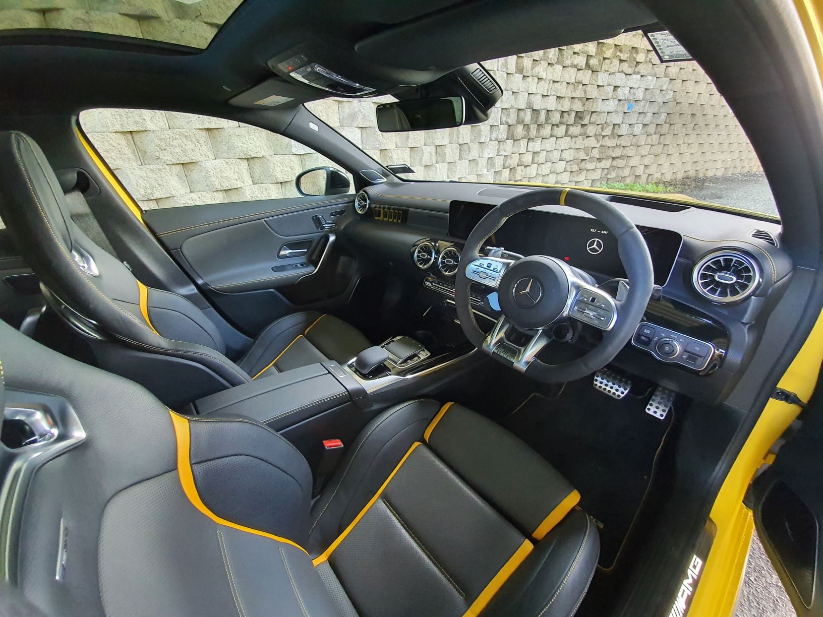 The black and yellow interior of the A45 S AMG.