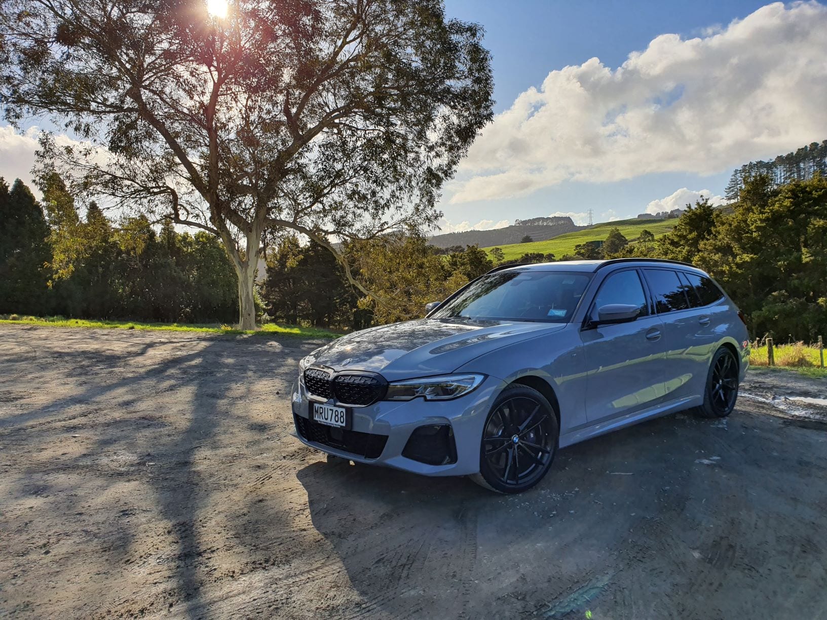 The M340i Touring pictured by a tree