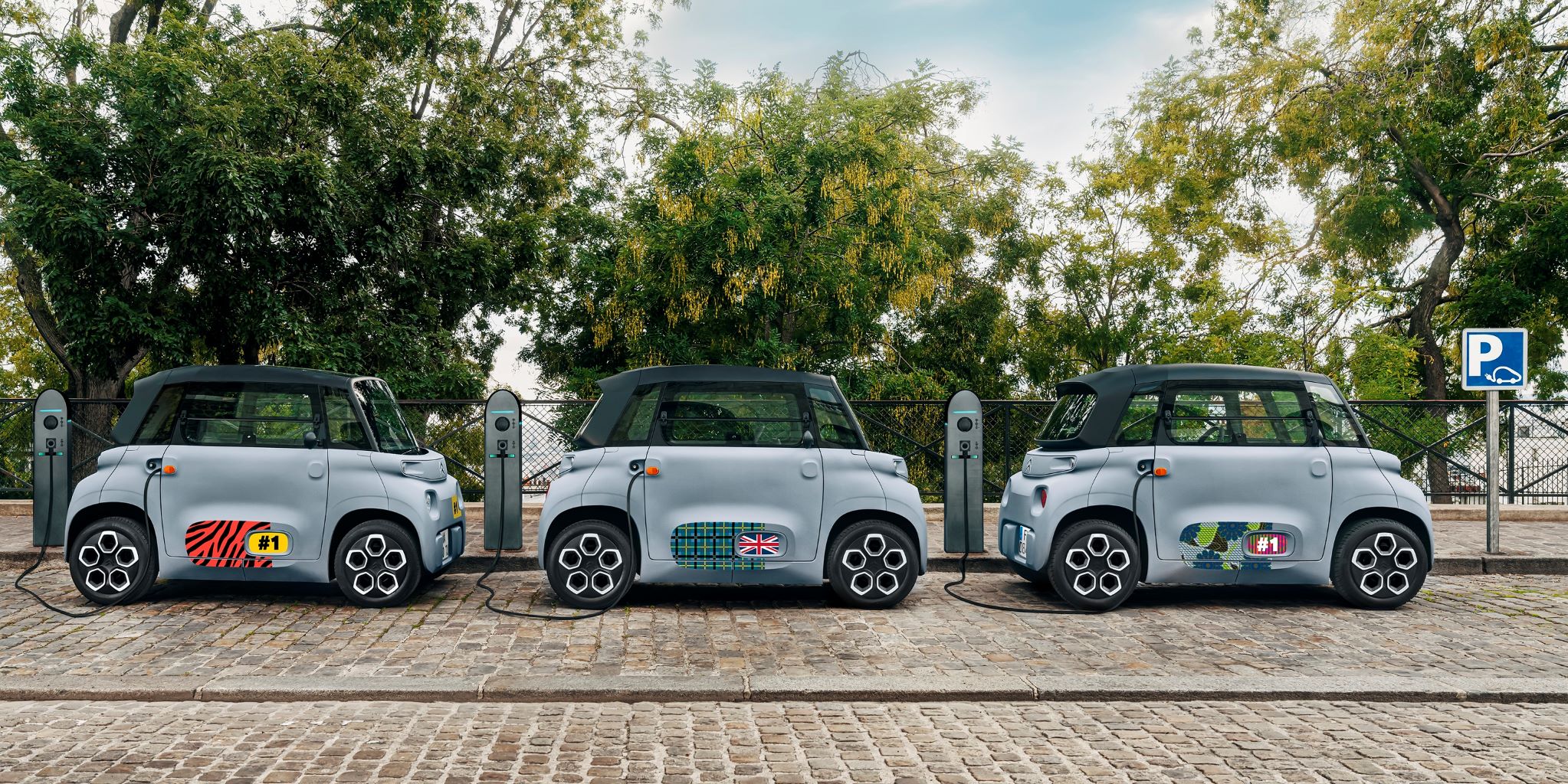 Three customized Citroen Amis charging