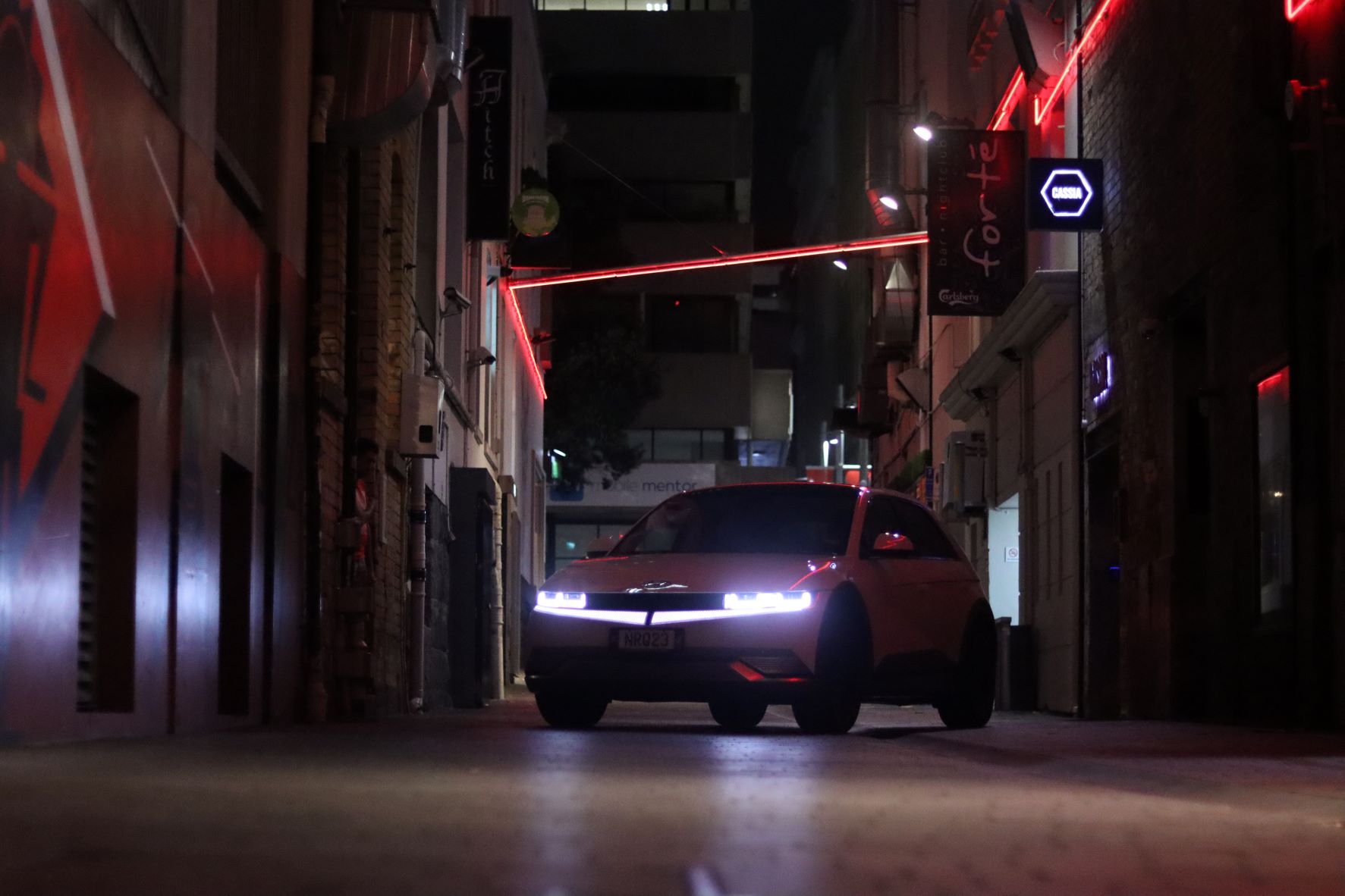 Front view of the Hyundai IONIQ 5 with LEDs in the background