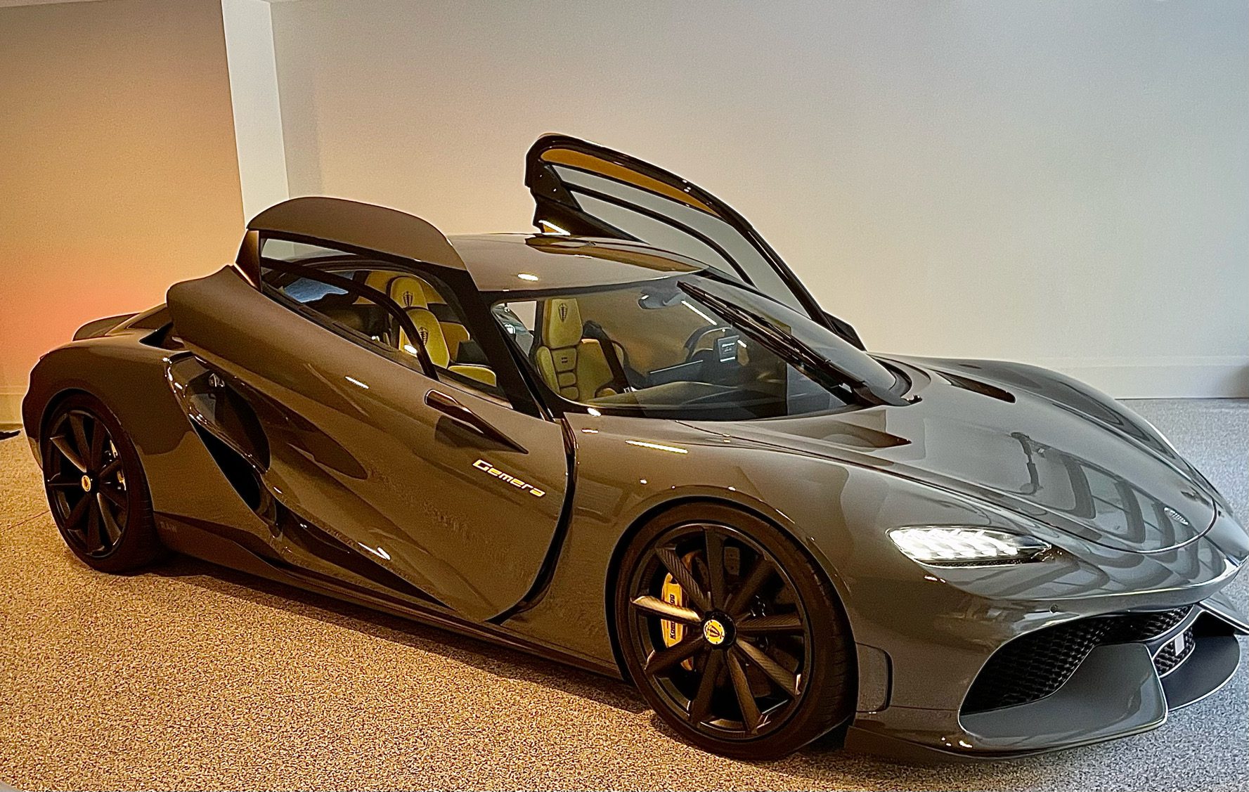 A front three quarters view of a grey Koenigsegg Gemera