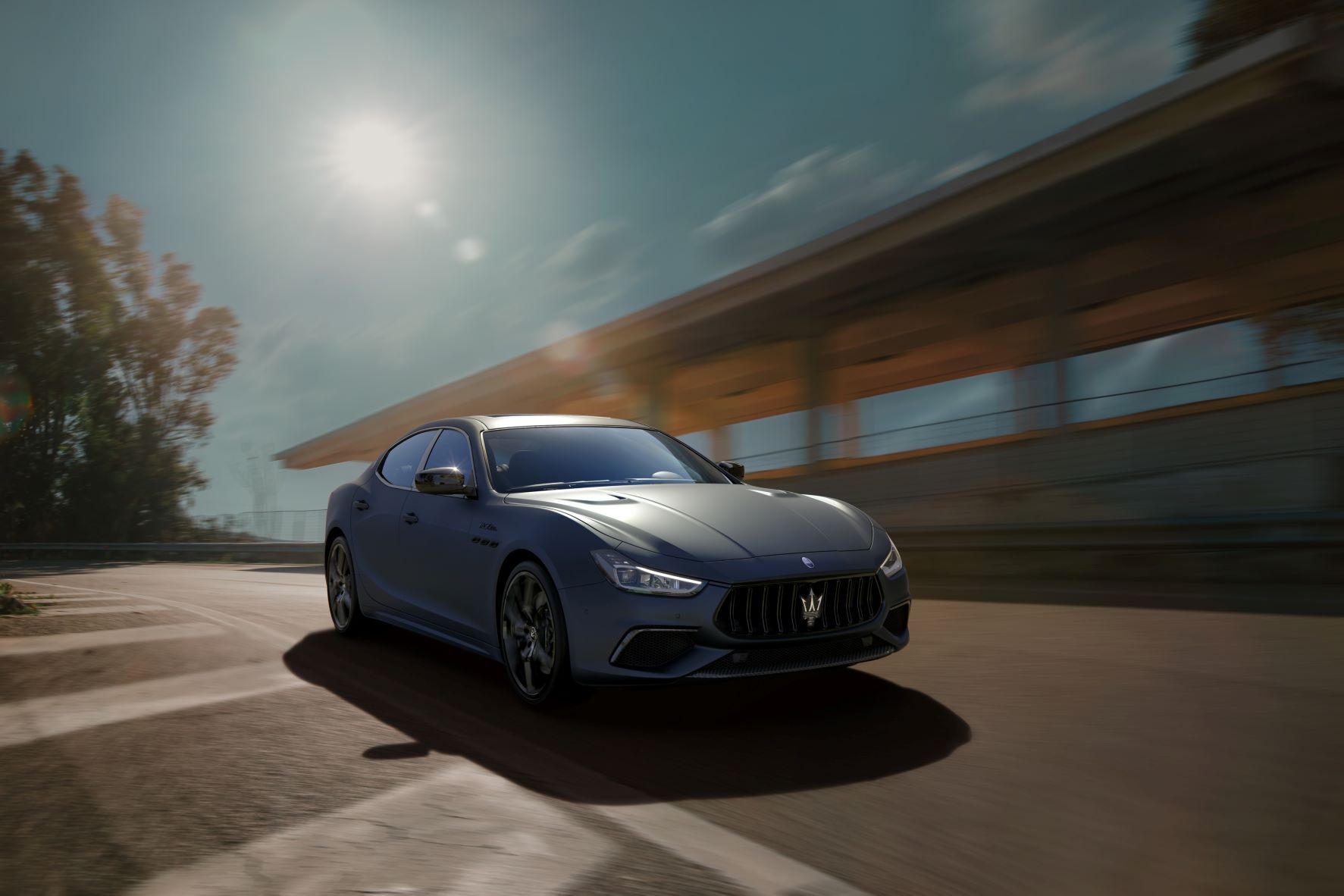 A dark blue Maserati Ghibli sedan in an urban environment