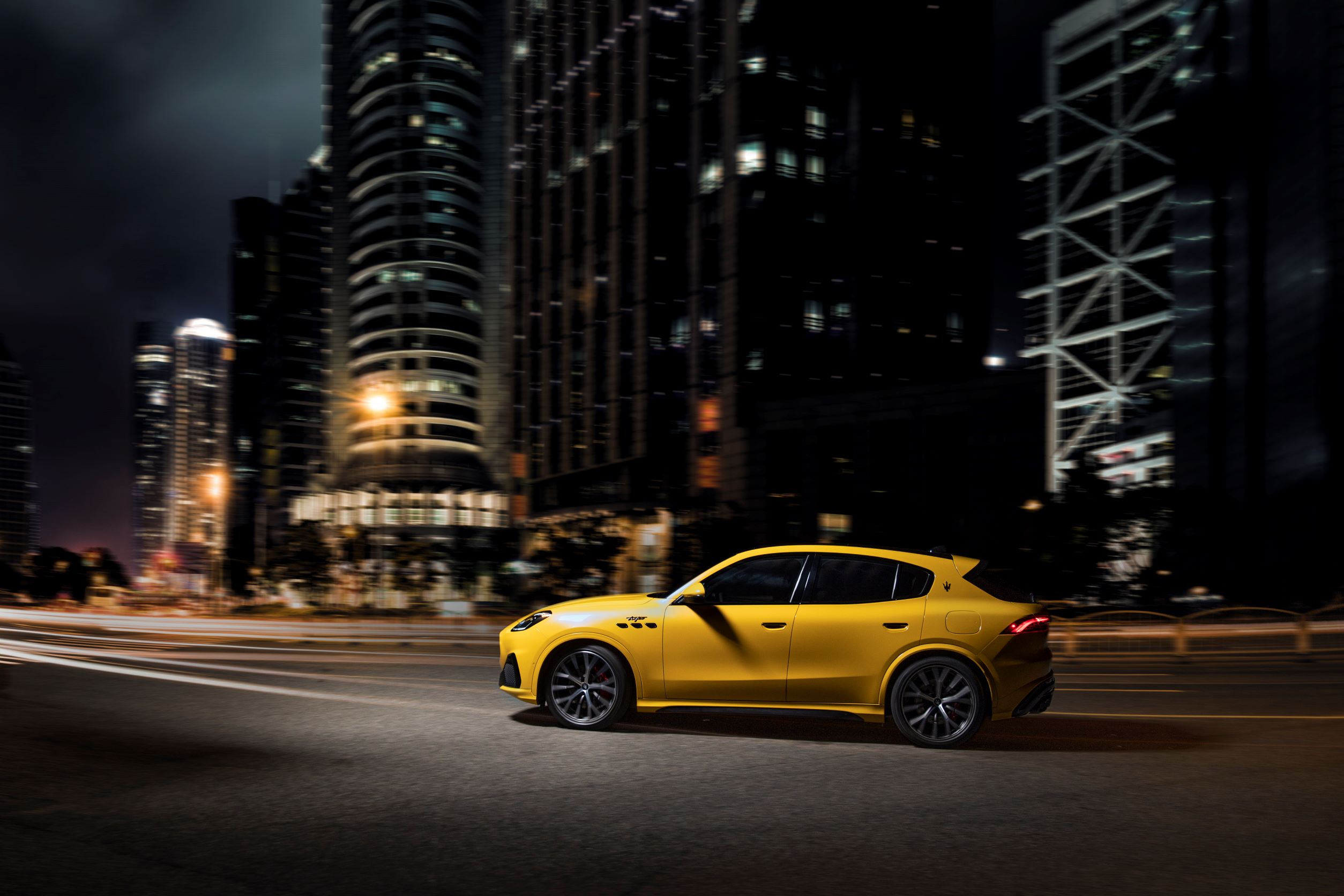 A yellow Maserati Grecale SUV at night