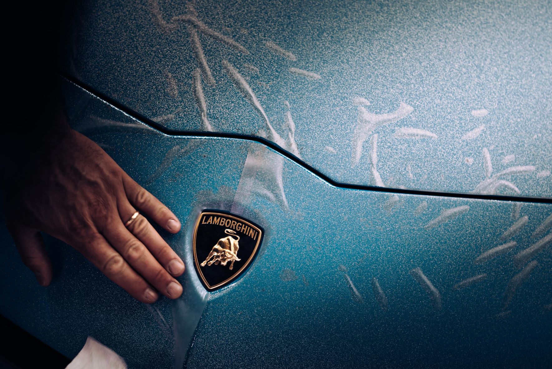Lamborghini badge being applied to the last ever Aventador