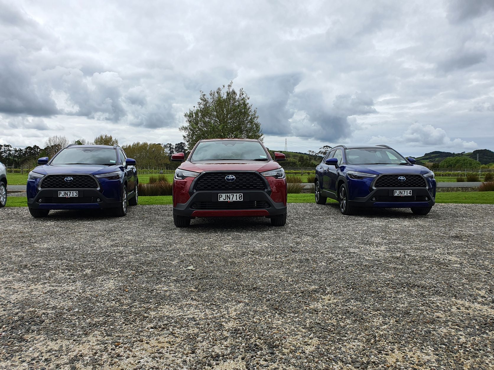Frontal view of the three Toyota Corolla Cross variants in two different colours