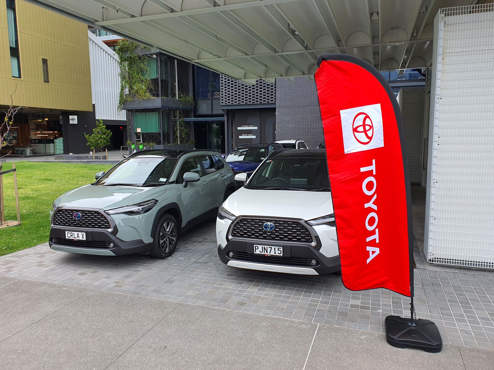 Red Toyota banner in front of a line-up of six Toyota Corolla Crosses