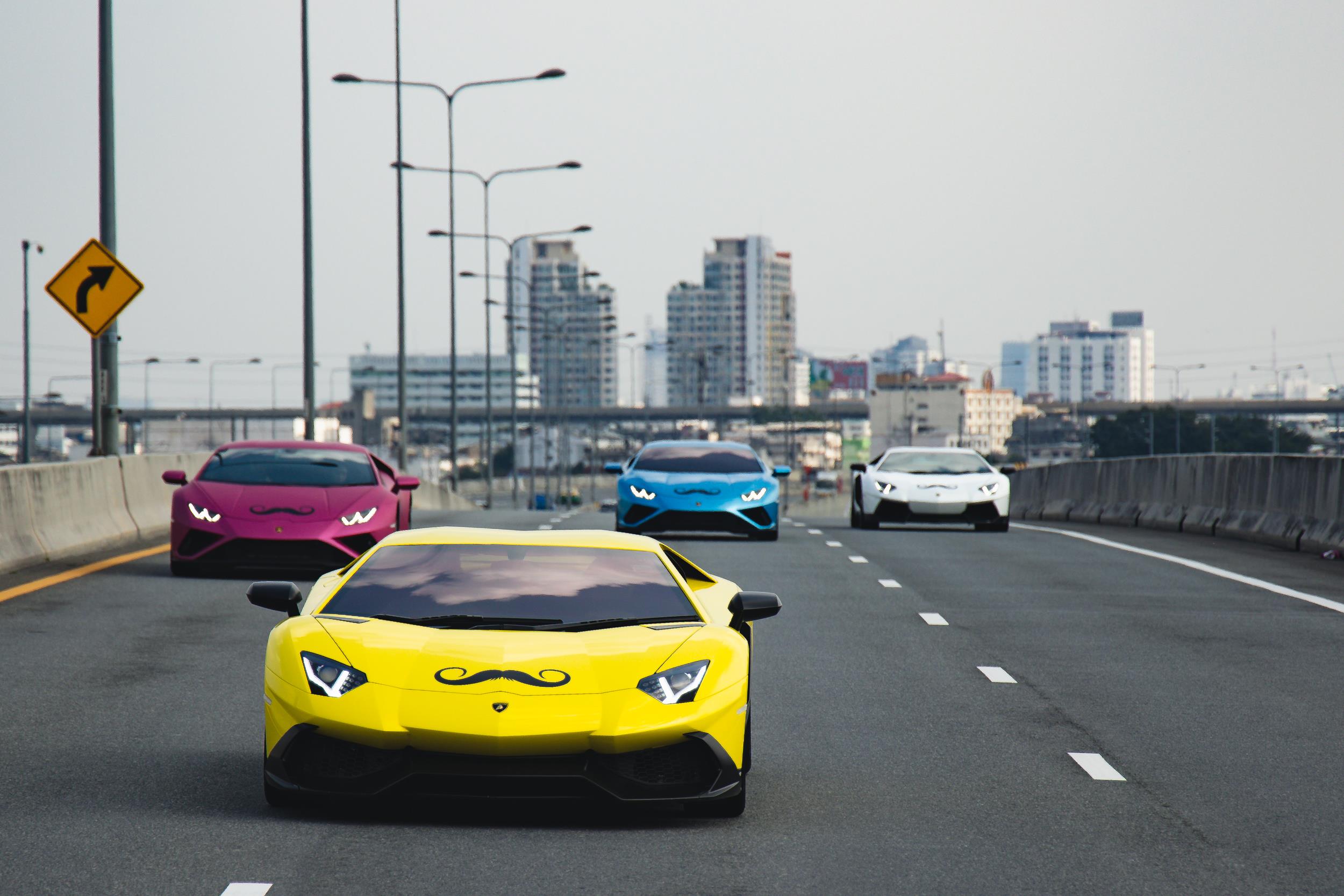 A group of Lamborghini cars bearing Movember stickers
