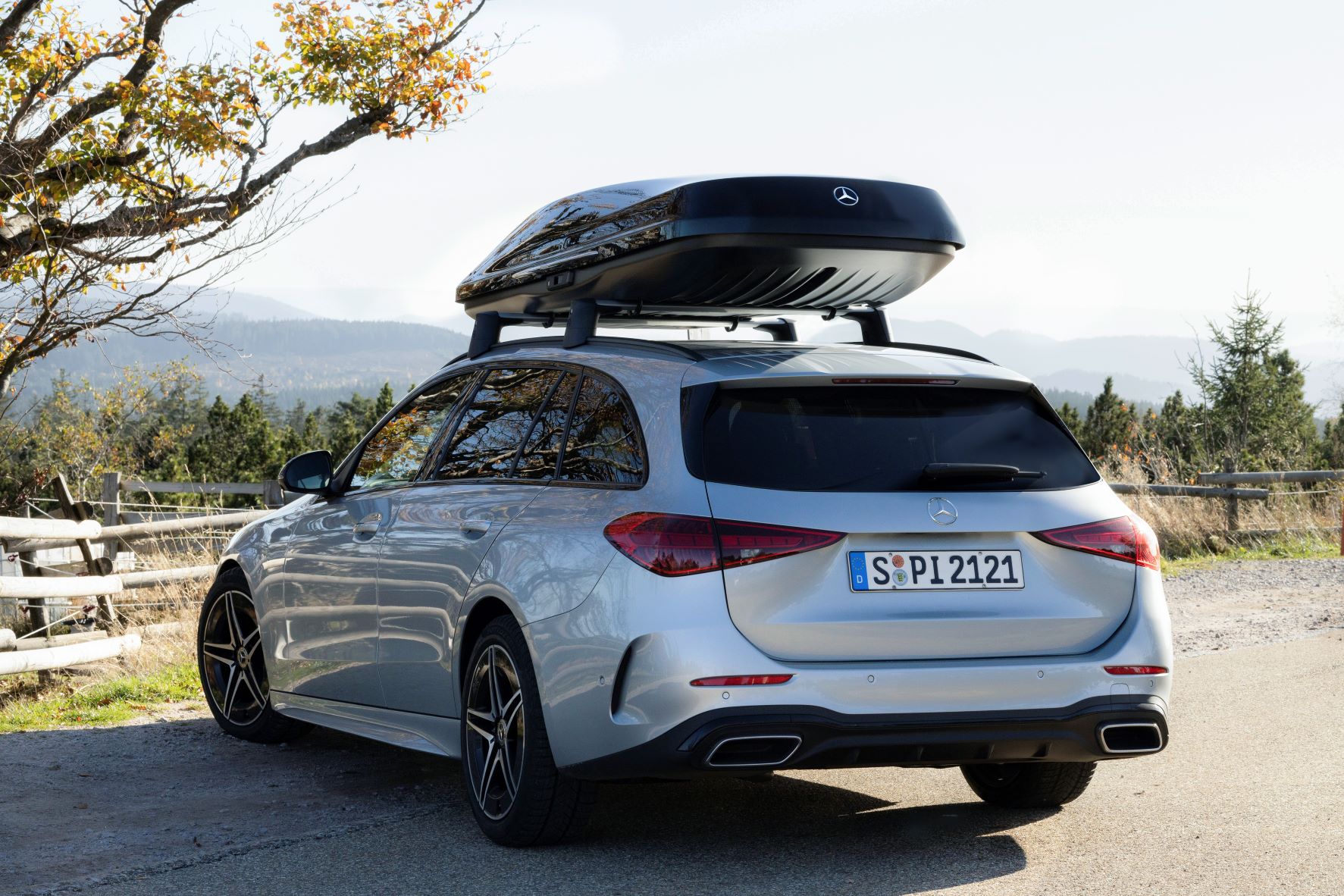 Rear three quarters view of a silver Mercedes-Benz C-Class estate with a new roof box mounted