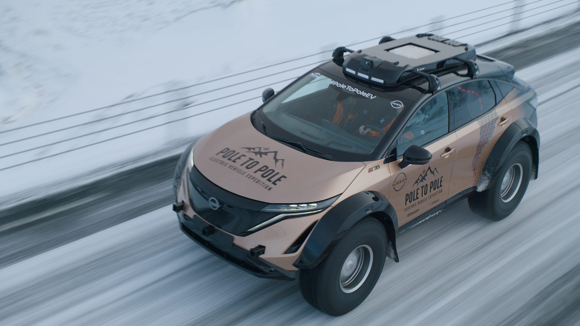 An overhead front three quarters shot of the Nissan Ariya Pole to Pole EV expedition car