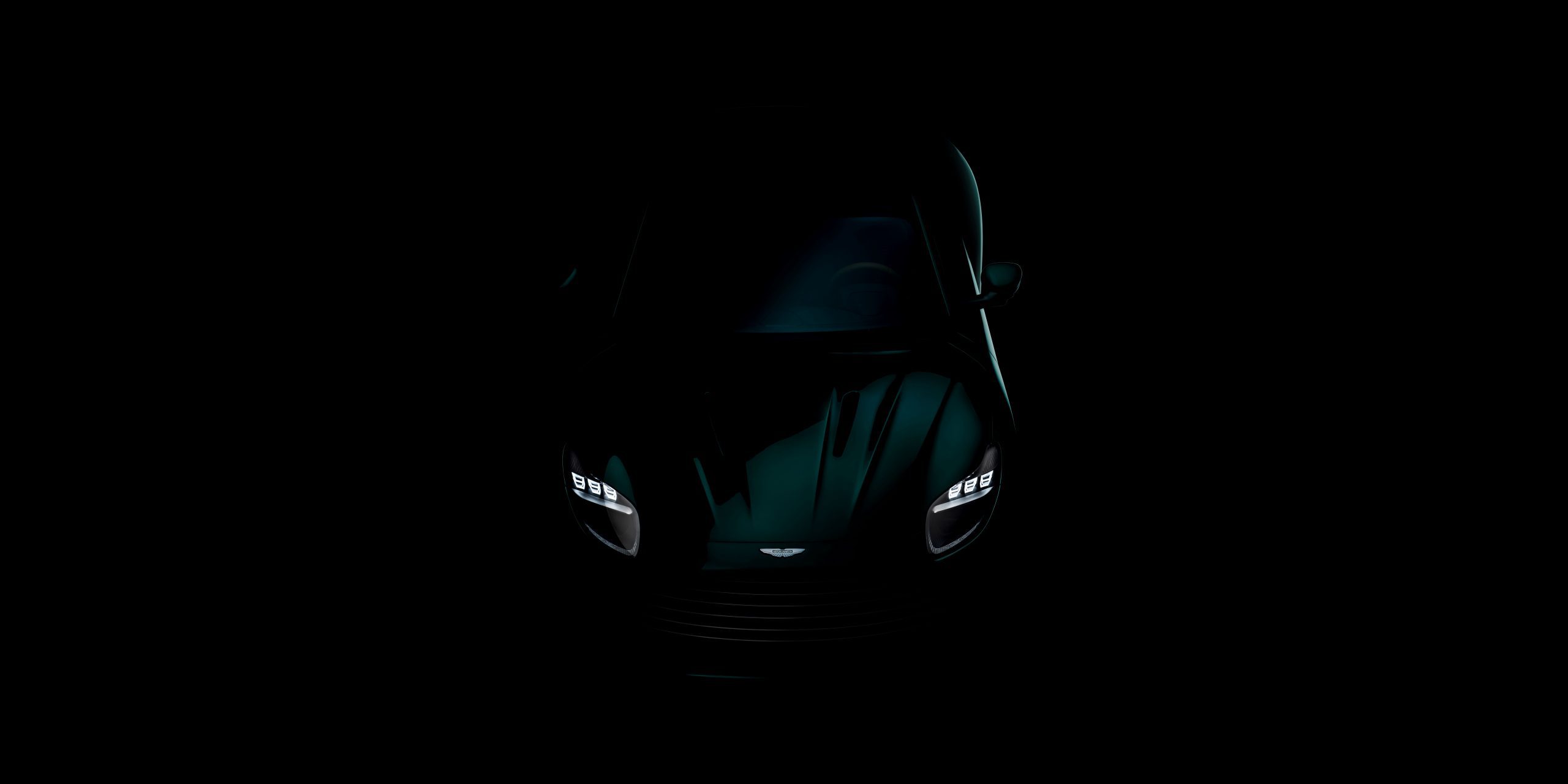 Overhead view of a teaser of the new Aston Martin DB coupe in green.