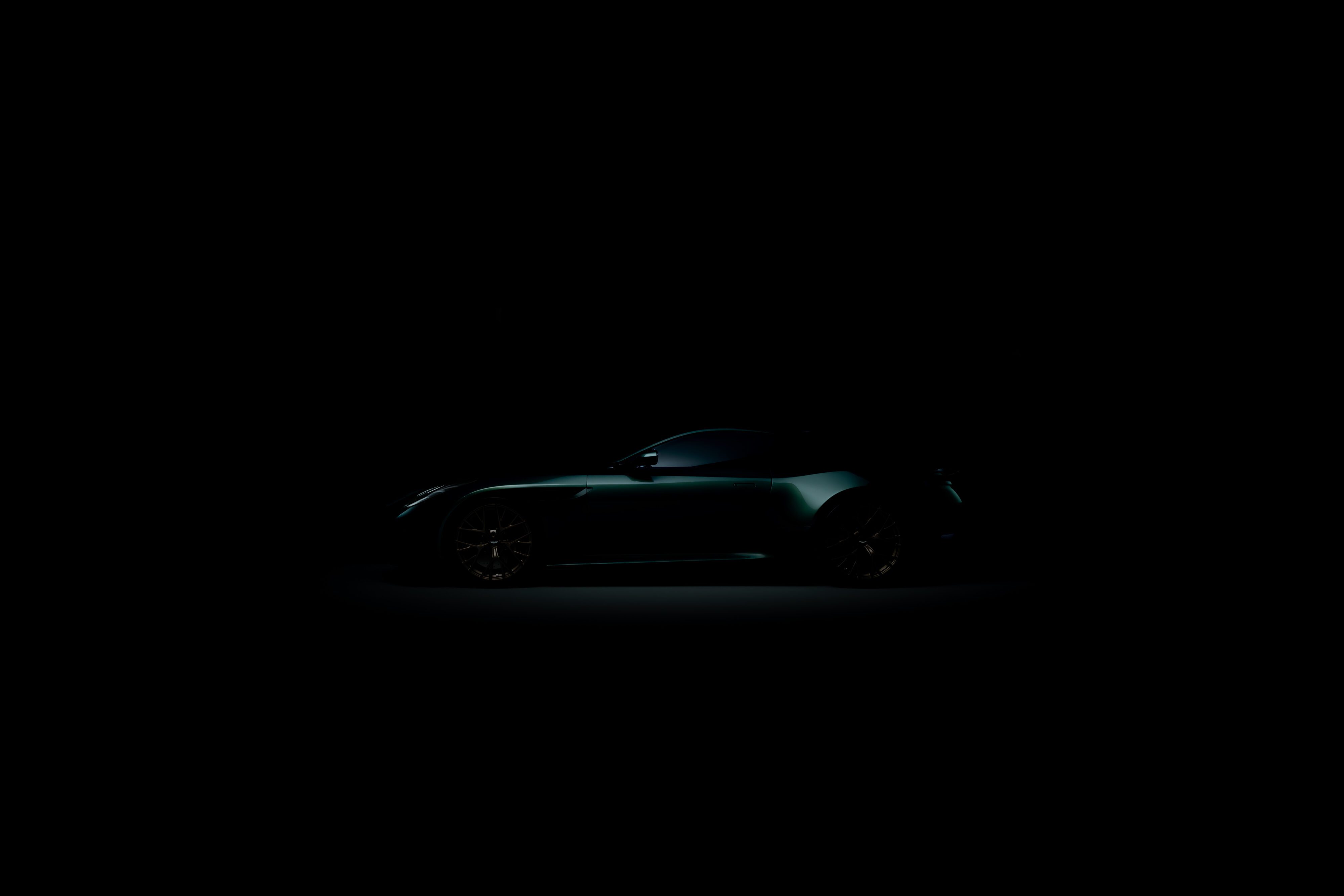 A view of the side profile of the new Aston Martin DB car in green from the teaser image.