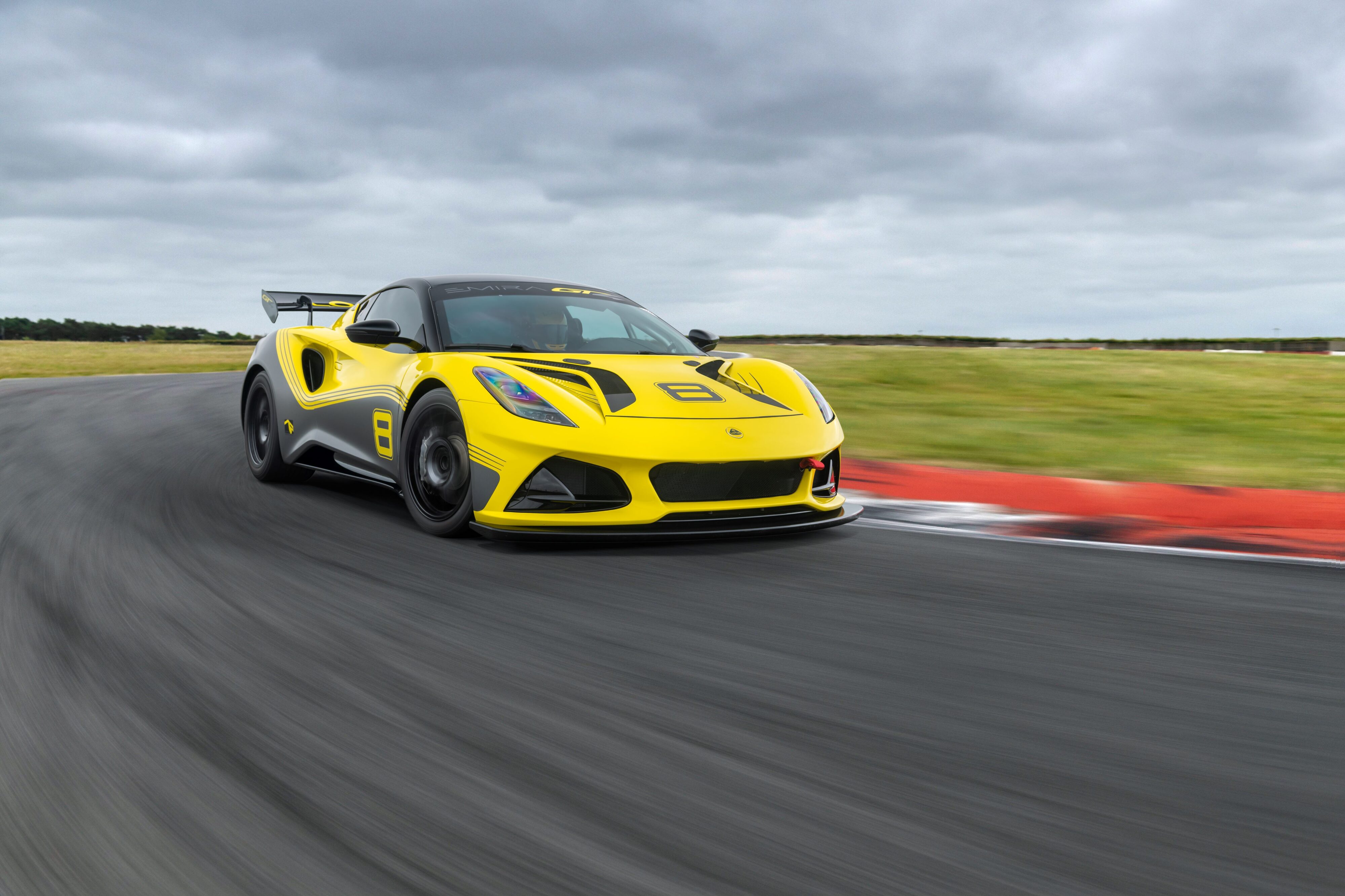 Rolling shot of a yellow Lotus Emira GT4