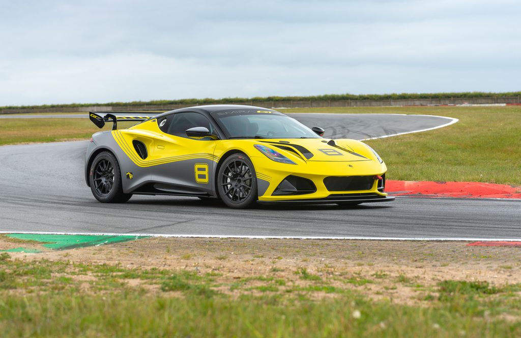 Front three quarters view of the Lotus Emira GT4 racecar in yellow