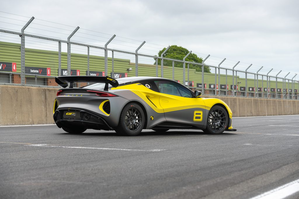 Rear three quarters view of the Lotus Emira GT4 racecar in yellow
