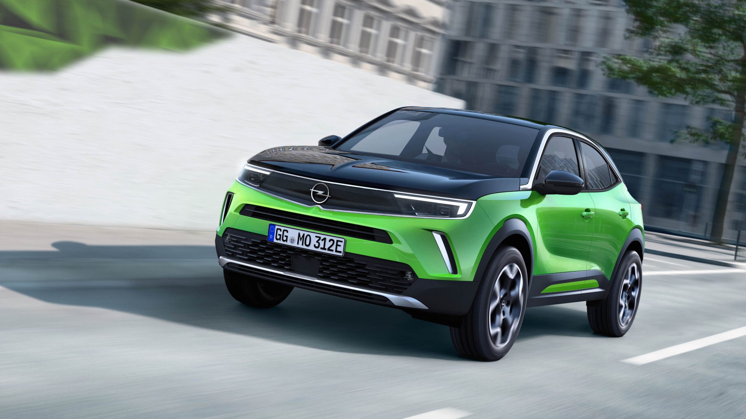 A rolling shot of an Opel Mokka e in Matcha Green