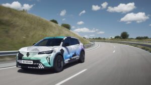 Motion shot of a new Renault Scenic e-tech under camouflage