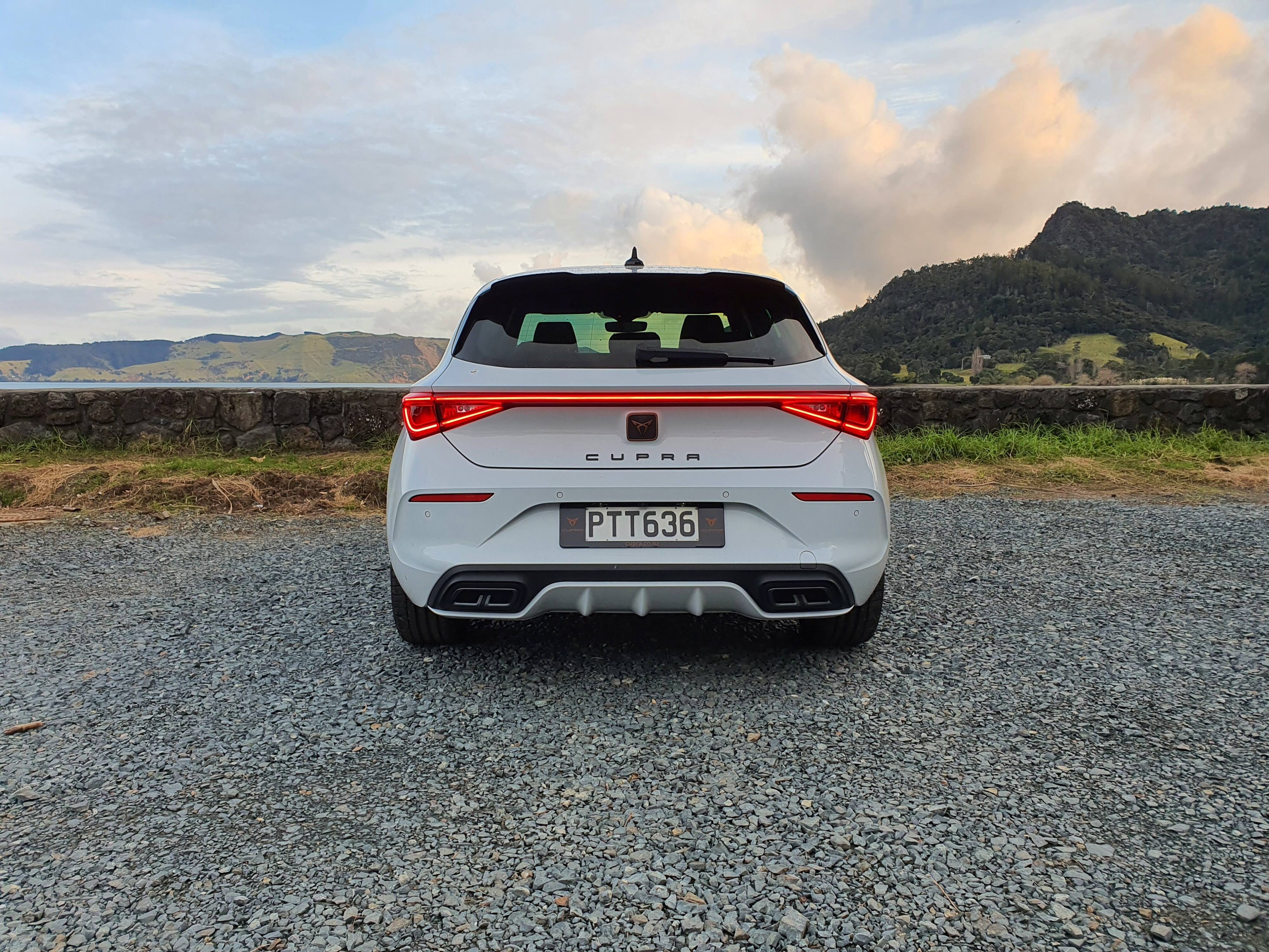 Rear view of a 2023 Cupra Leon V hatchback in 'Nevada White'