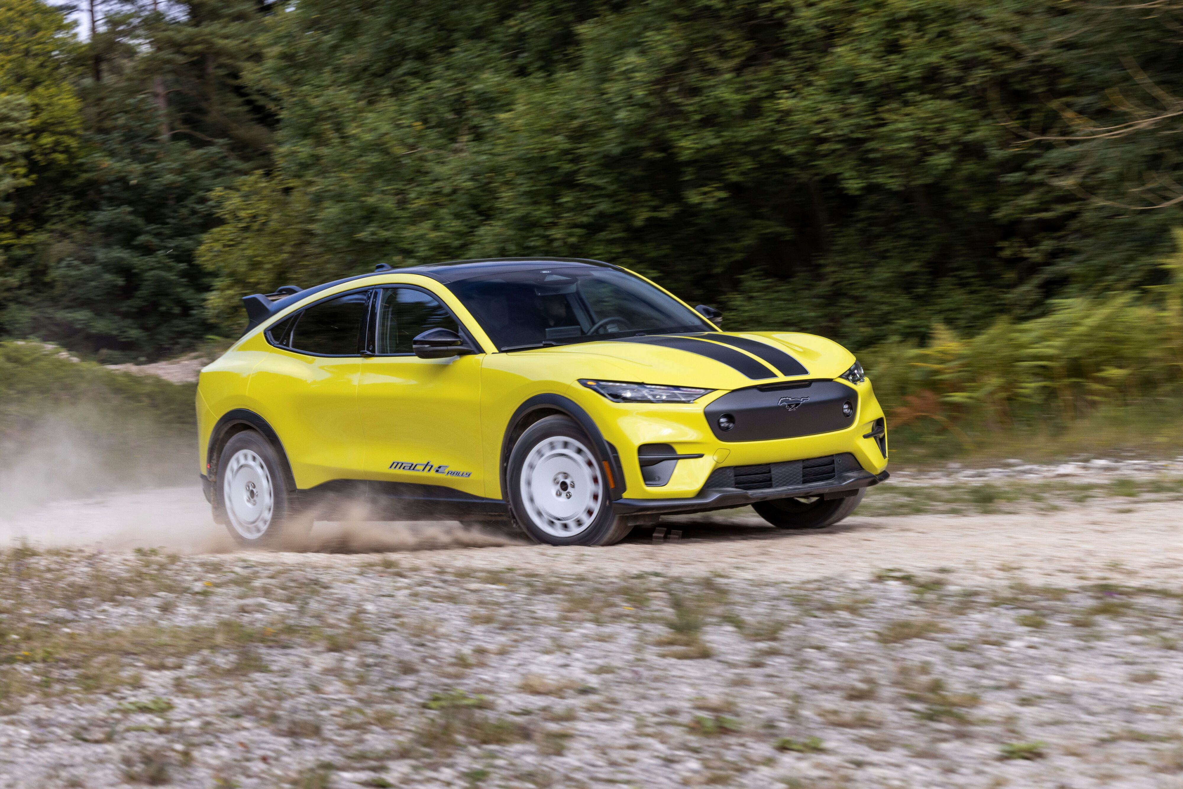 Motion shot of a 2023 Ford Mustang Mach-E GT on a rally stage.
