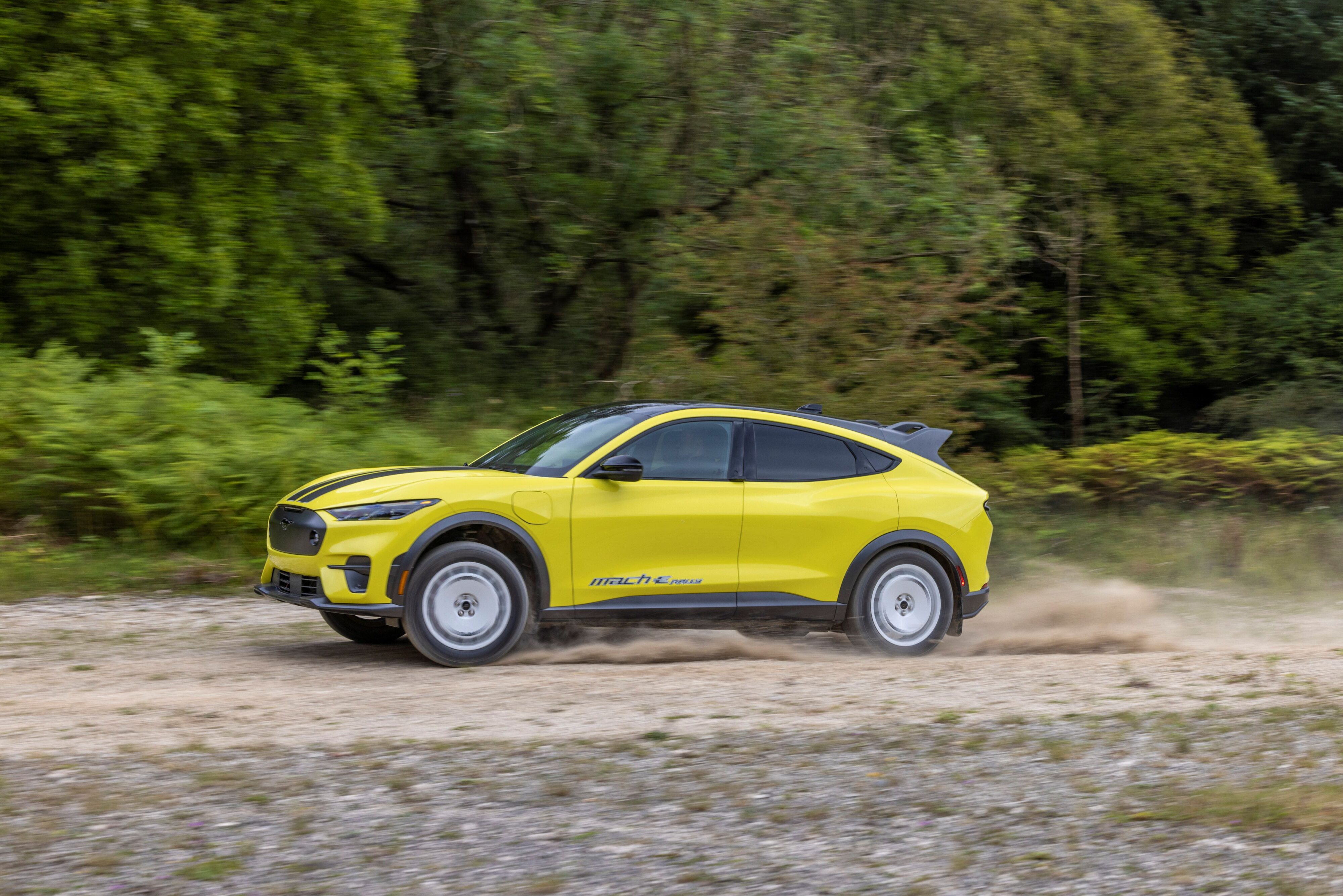 Side view of a 2023 Ford Mustang Mach-E Rally in motion.