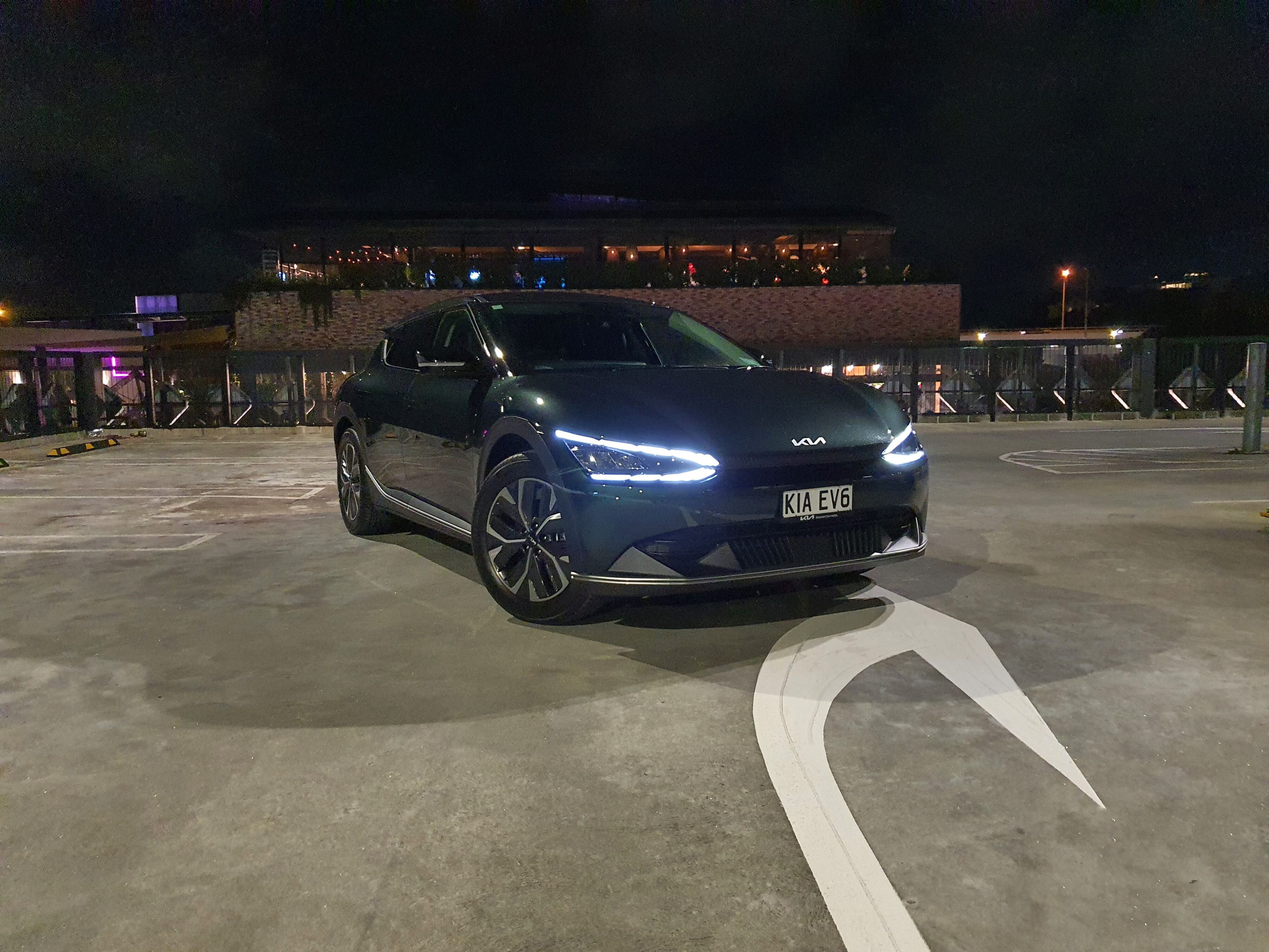 Front three quarters view of a 2023 Deep Forest Green Kia EV6 Air Long Range.