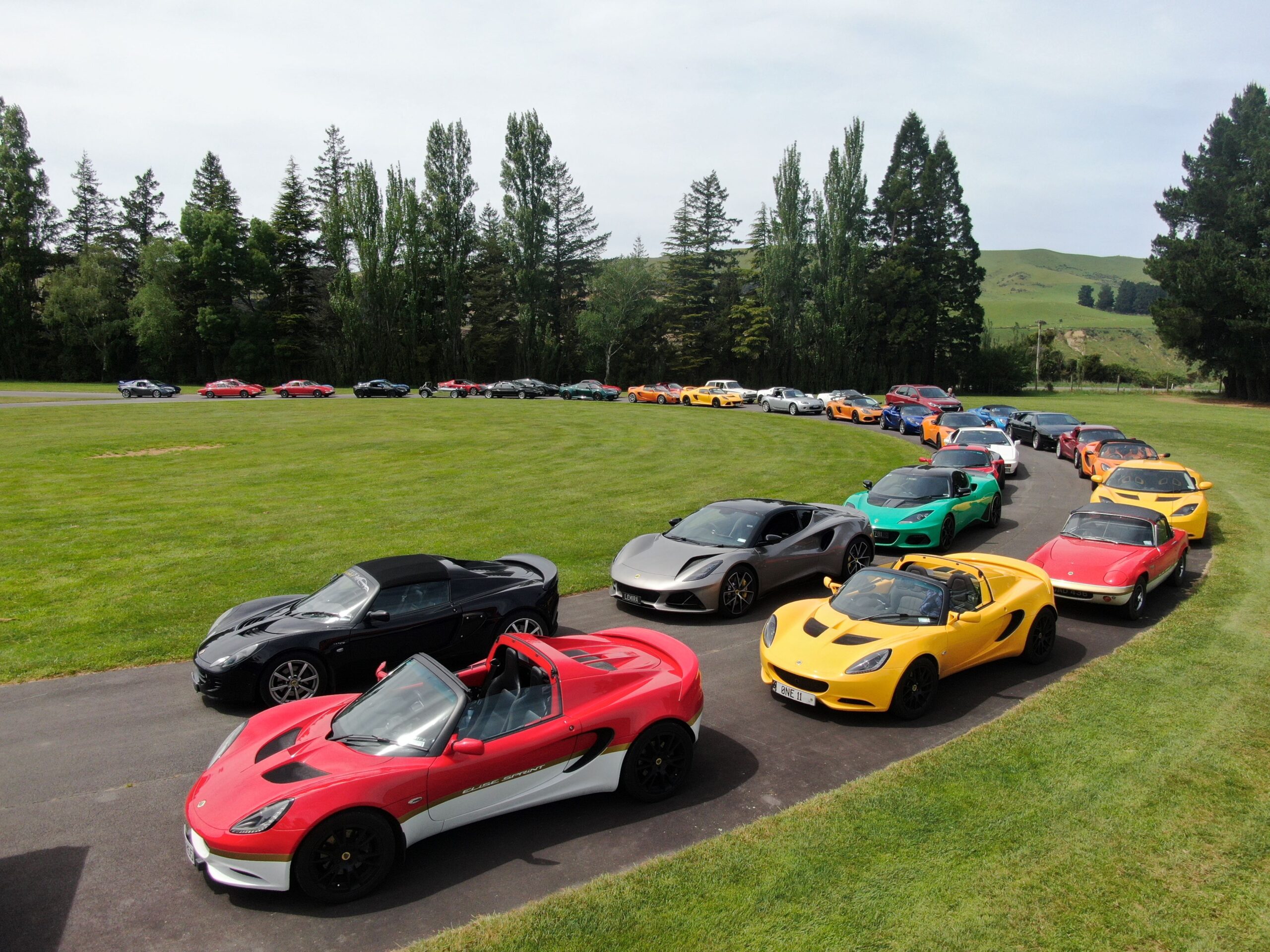 Several Lotus vehicles parked in a display formation as part of the Lotus 75th Anniversary celebrations in 2023. Photo Credit: Luan You