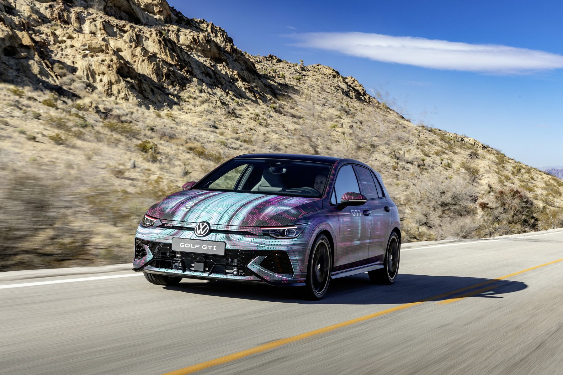 Promotional moving shot of a new Volkswagen Golf GTI.