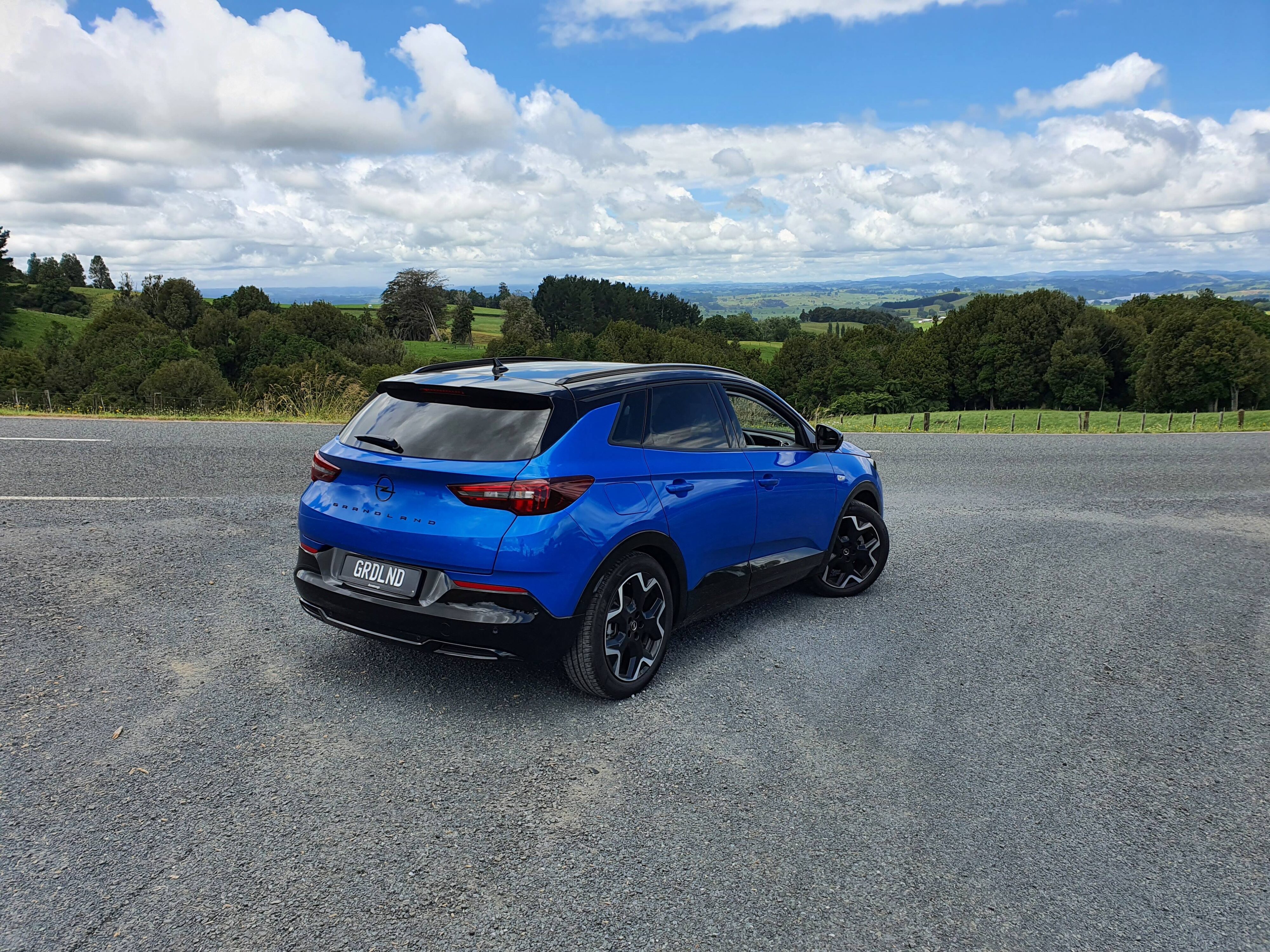 Rear three quarters view of a Cobalt Blue Opel Grandland SRi at Sanctuary Mountain.
