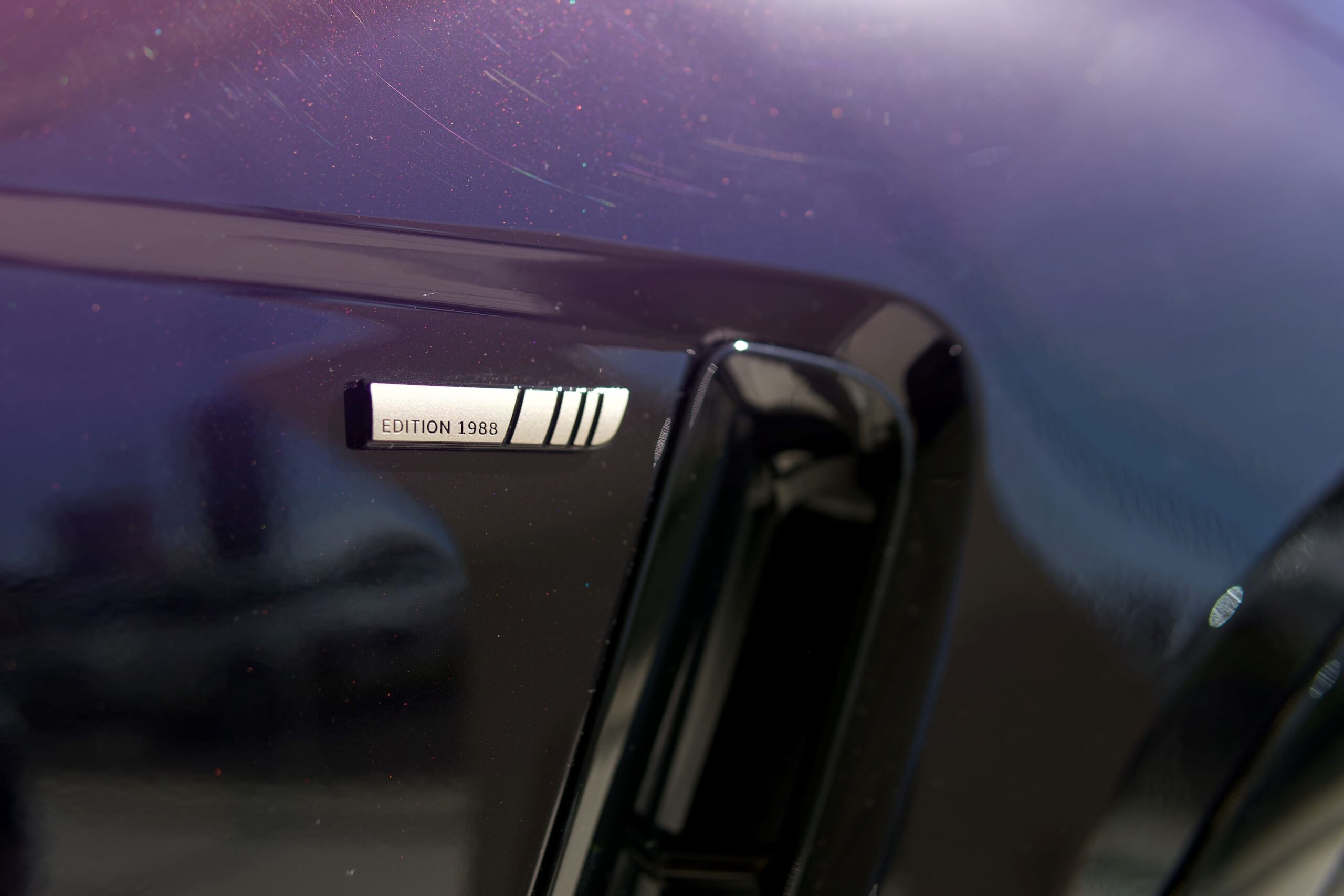 A Sunset Gold Satin 'Edition 1988' badge on the side of a Jaguar F-Pace SVR Edition 1988.