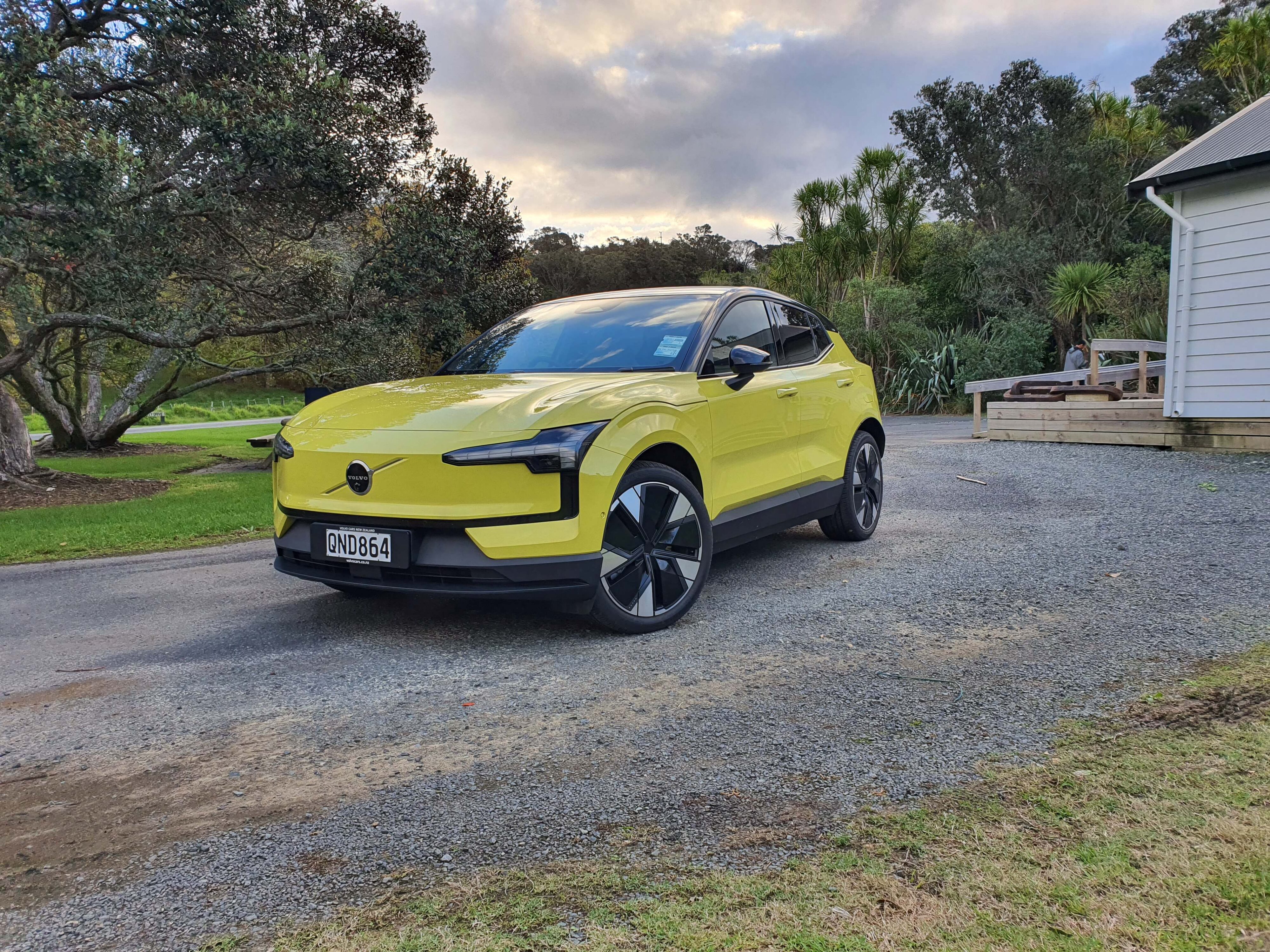 Front three quarters view of a 2024 Volvo EX30 in Moss Yellow.