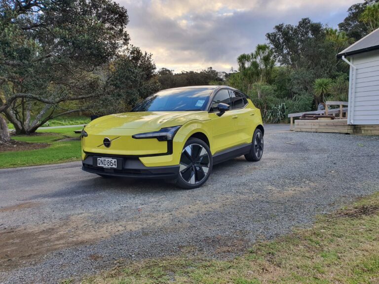 Front three quarters view of a 2024 Volvo EX30 in Moss Yellow.