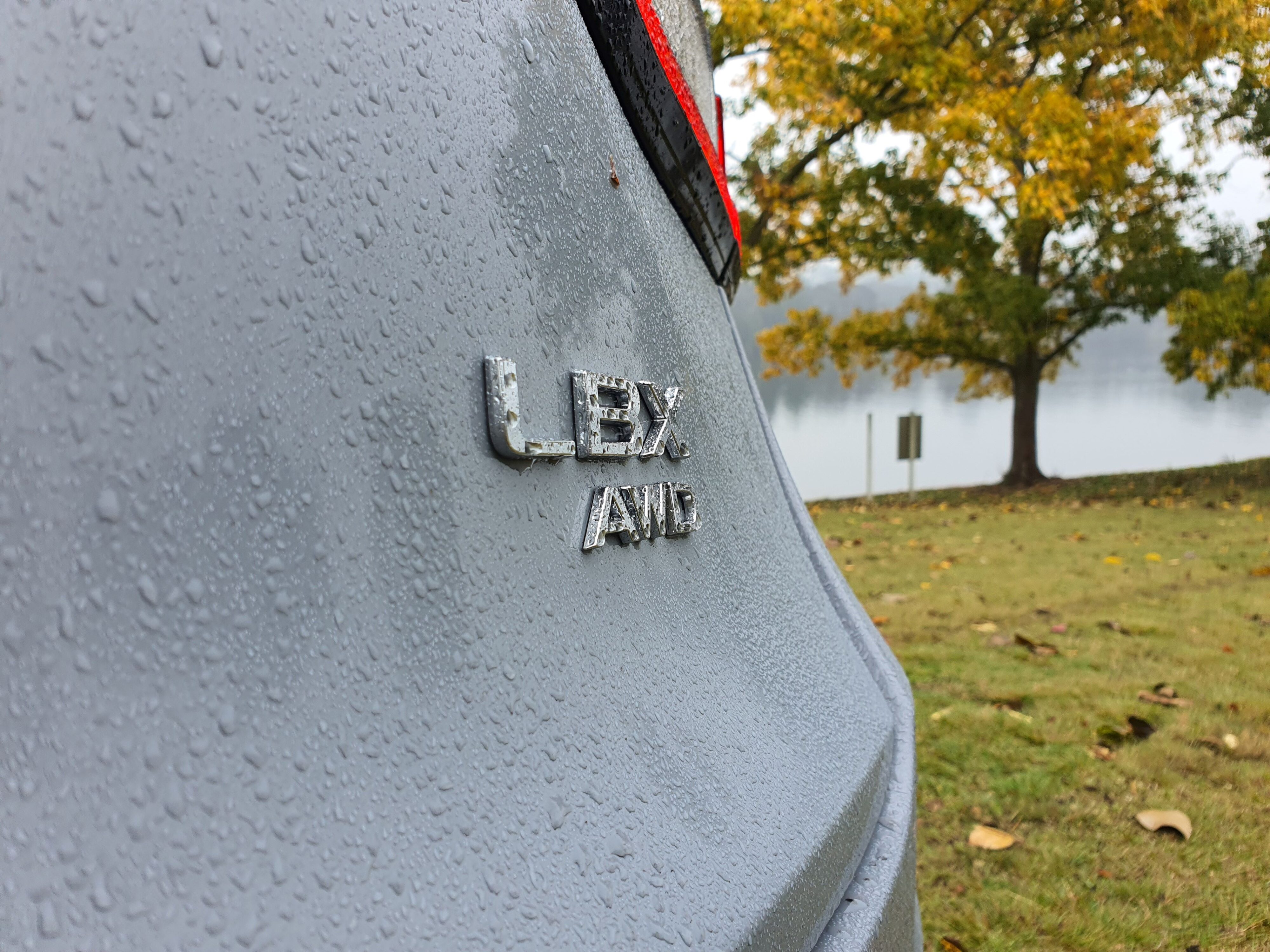 LBX AWD badge on the rear of a 2024 Lexus LBX Relax AWD in Concrete Grey.