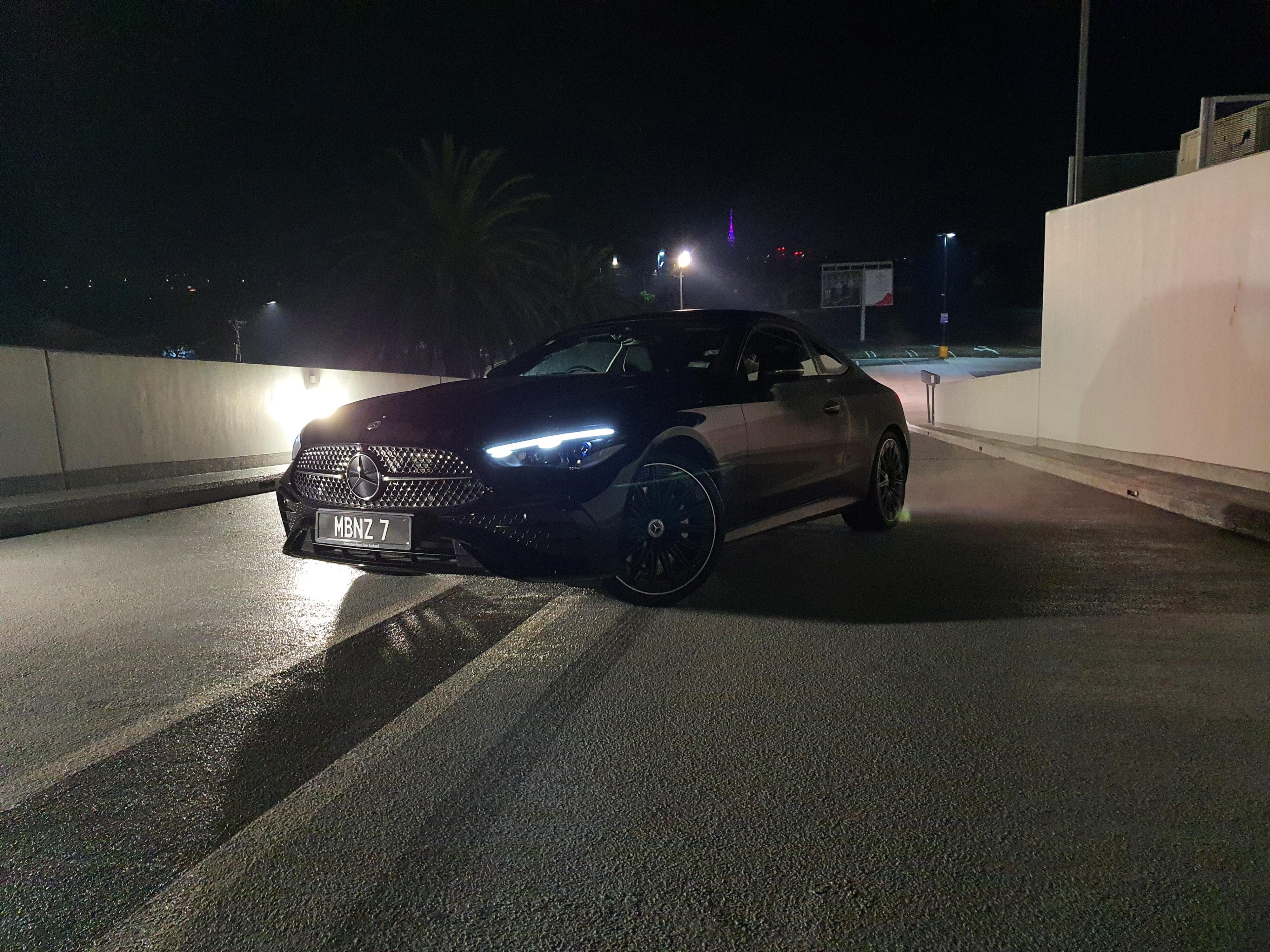 A night time shot of a Mercedes-Benz CLE300 4MATIC in Black.