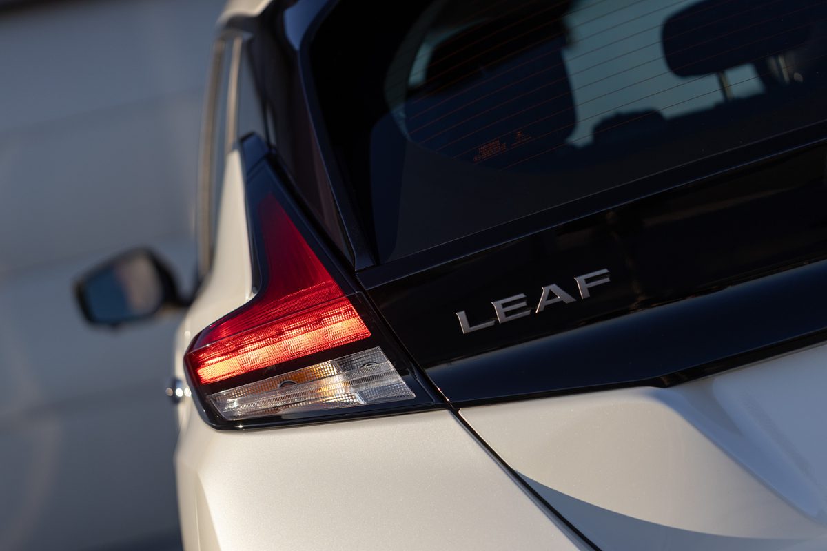 Close-up shot of the Leaf badge on a Gen 2 Nissan Leaf in white.