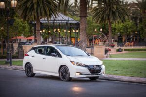 A White Gen 2 Nissan Leaf parked by the side of a street.