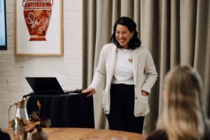 Dr Stella Clarke presenting to a room of journalists at The Hotel Britomart in Auckland, New Zealand.
