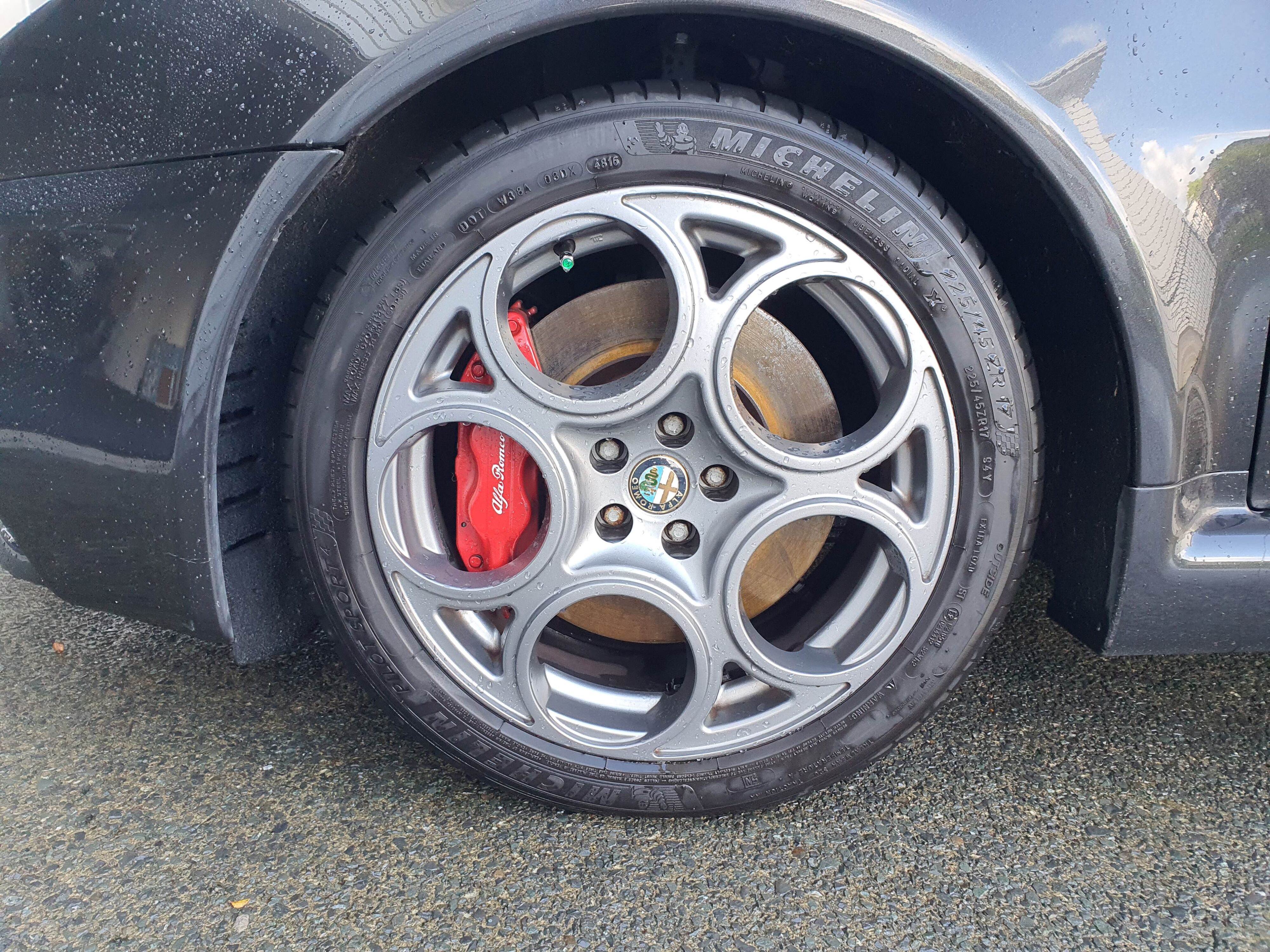 A photo of a clean front left wheel on a 2004 Alfa Romeo 147 GTA after using Armor All's new Wash & Wax and Bug & Tar Remover.
