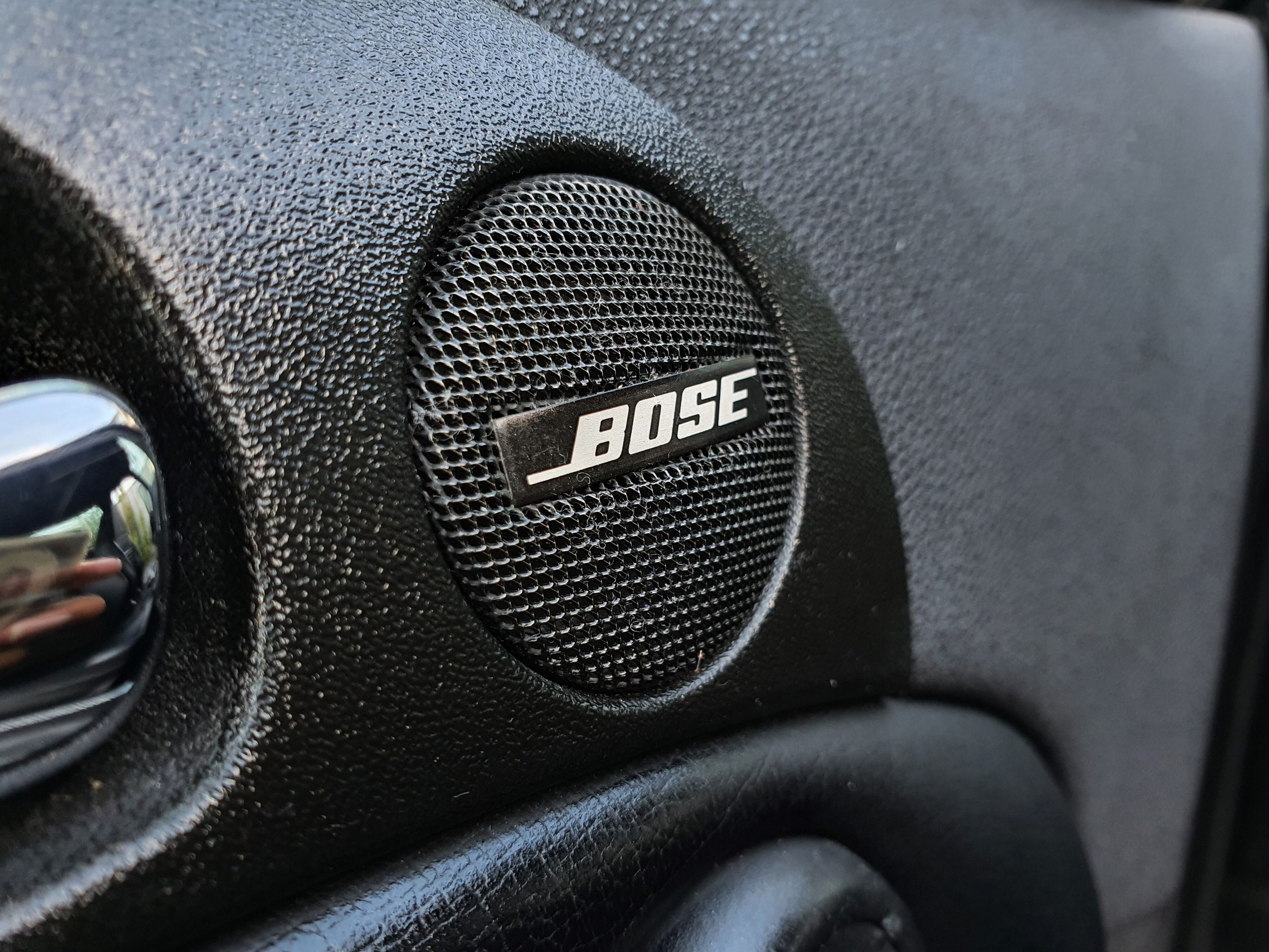 Photo of the Bose speaker cover on the interior of a 2004 Alfa Romeo 147 GTA after using Armor All's new Interior Protectant spray.