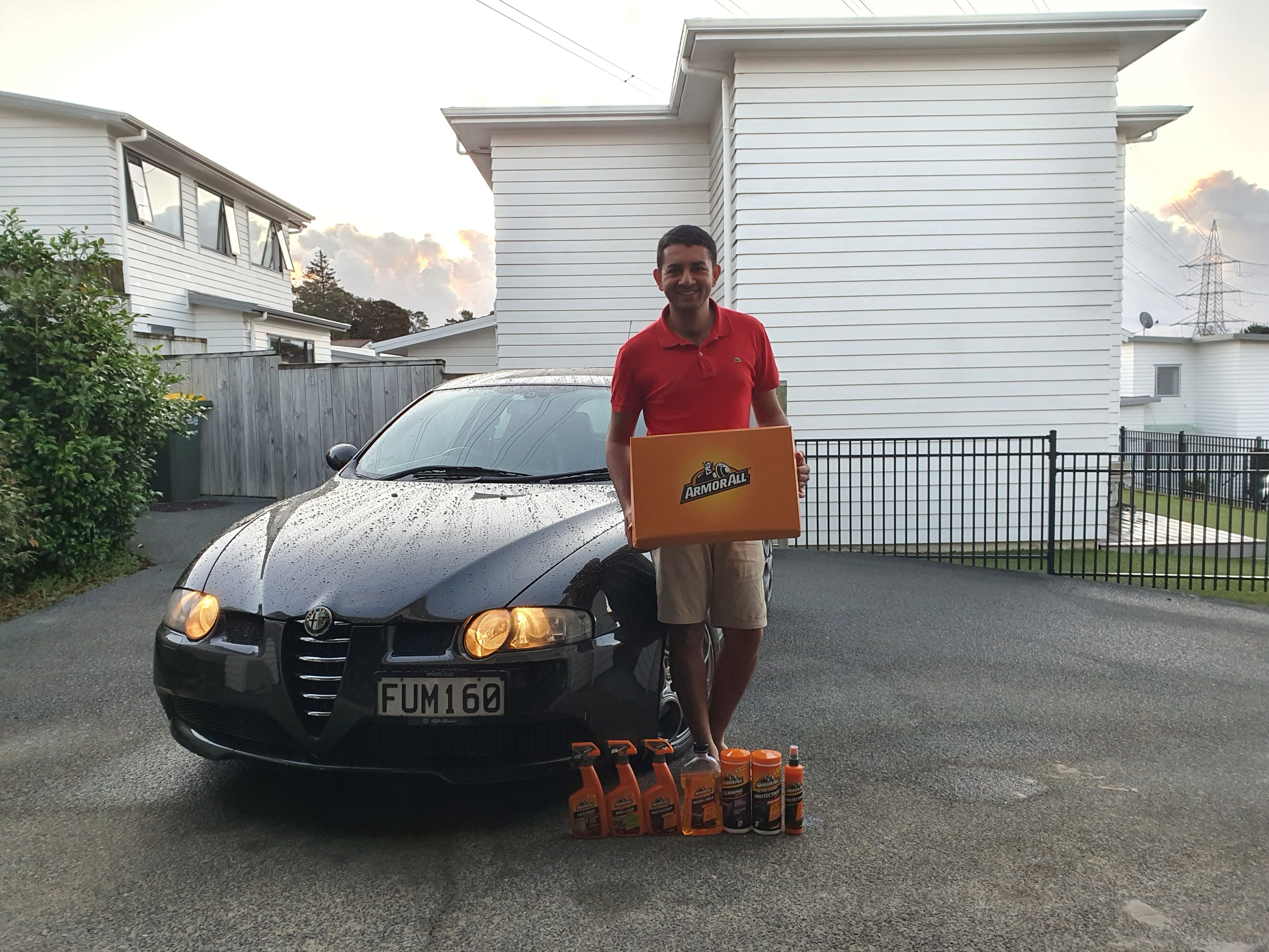 A photo of Matthew D'Souza of Tarmac Life pictured with his 2004 Alfa Romeo 147 GTA and Armor All's new range of cleaning products.