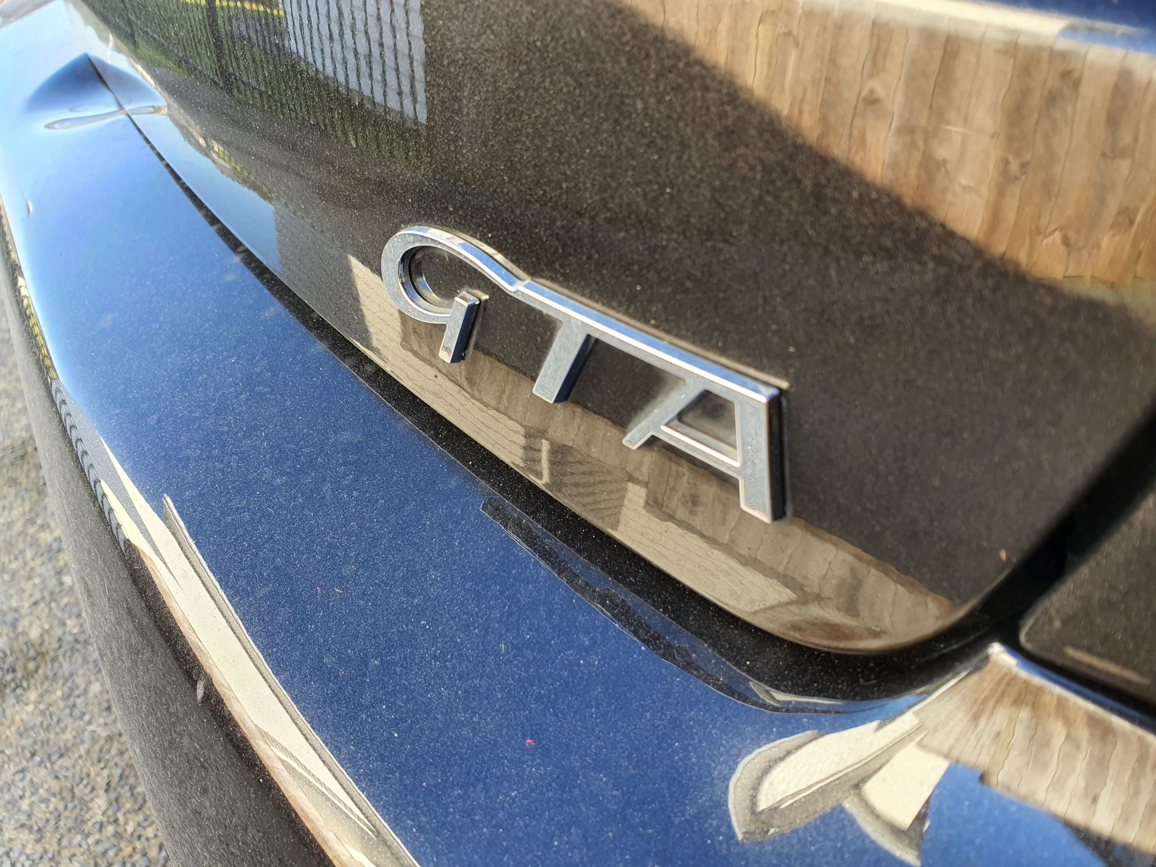 A shot of the unclean rear GTA badge on a 2004 Alfa Romeo 147 GTA.