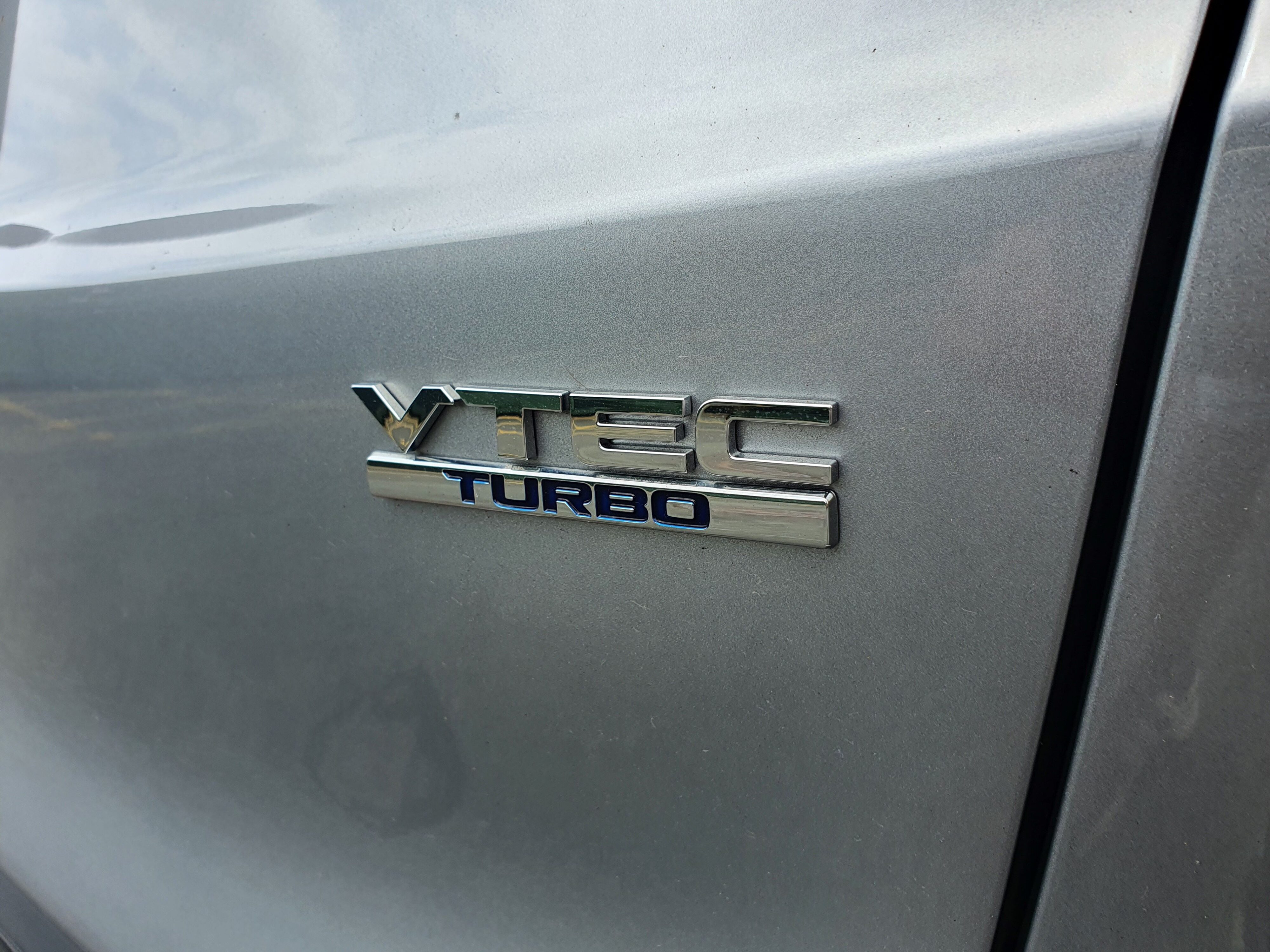 VTEC Turbo badge on the rear right of a 2024 Honda CR-V AWD in Silver.
