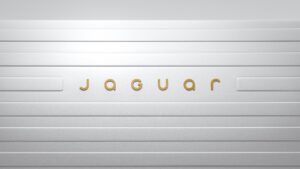 The new Jaguar text logo with gold font on a white background.