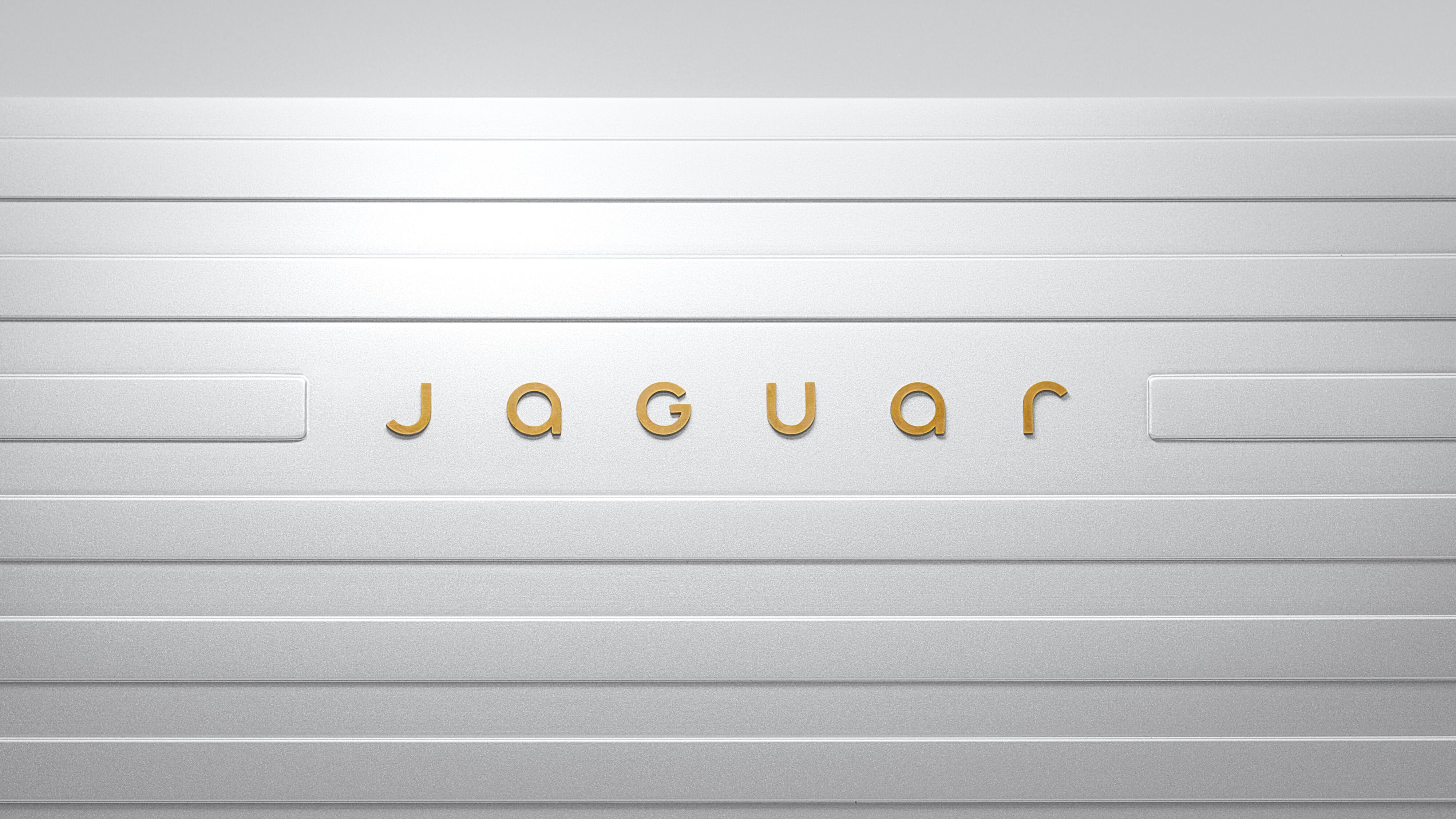 The new Jaguar text logo with gold font on a white background.