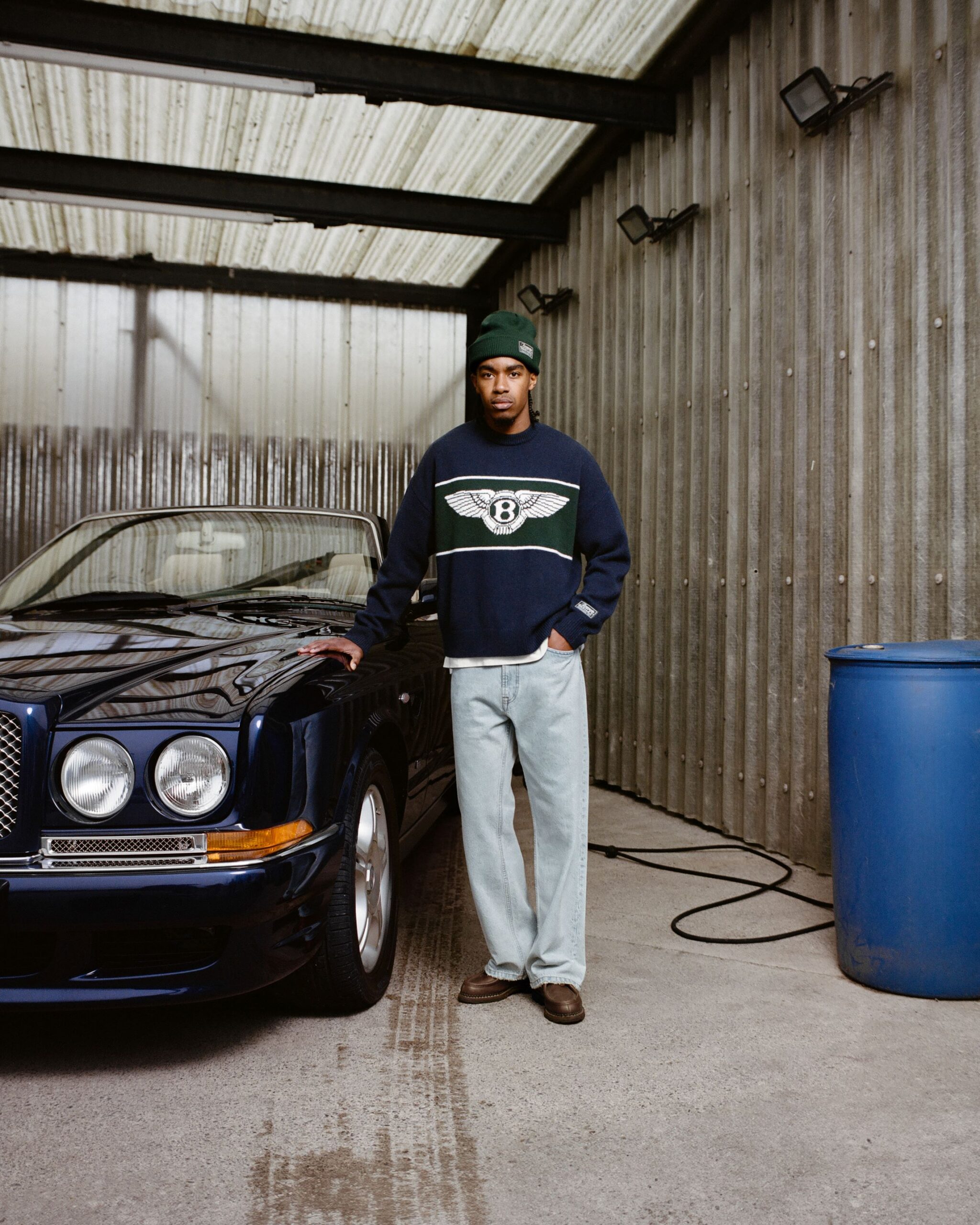 A photo of a model dressed in the Bentley and Picante collection posing next to a classic Bentley.