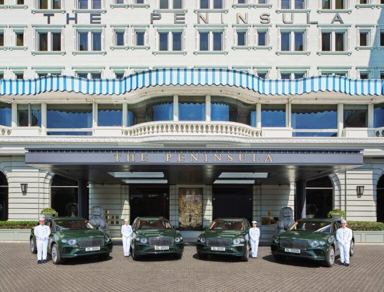 Four dark green Bentley Bentayga EWBs parked in front of The Peninsula Hong Kong.