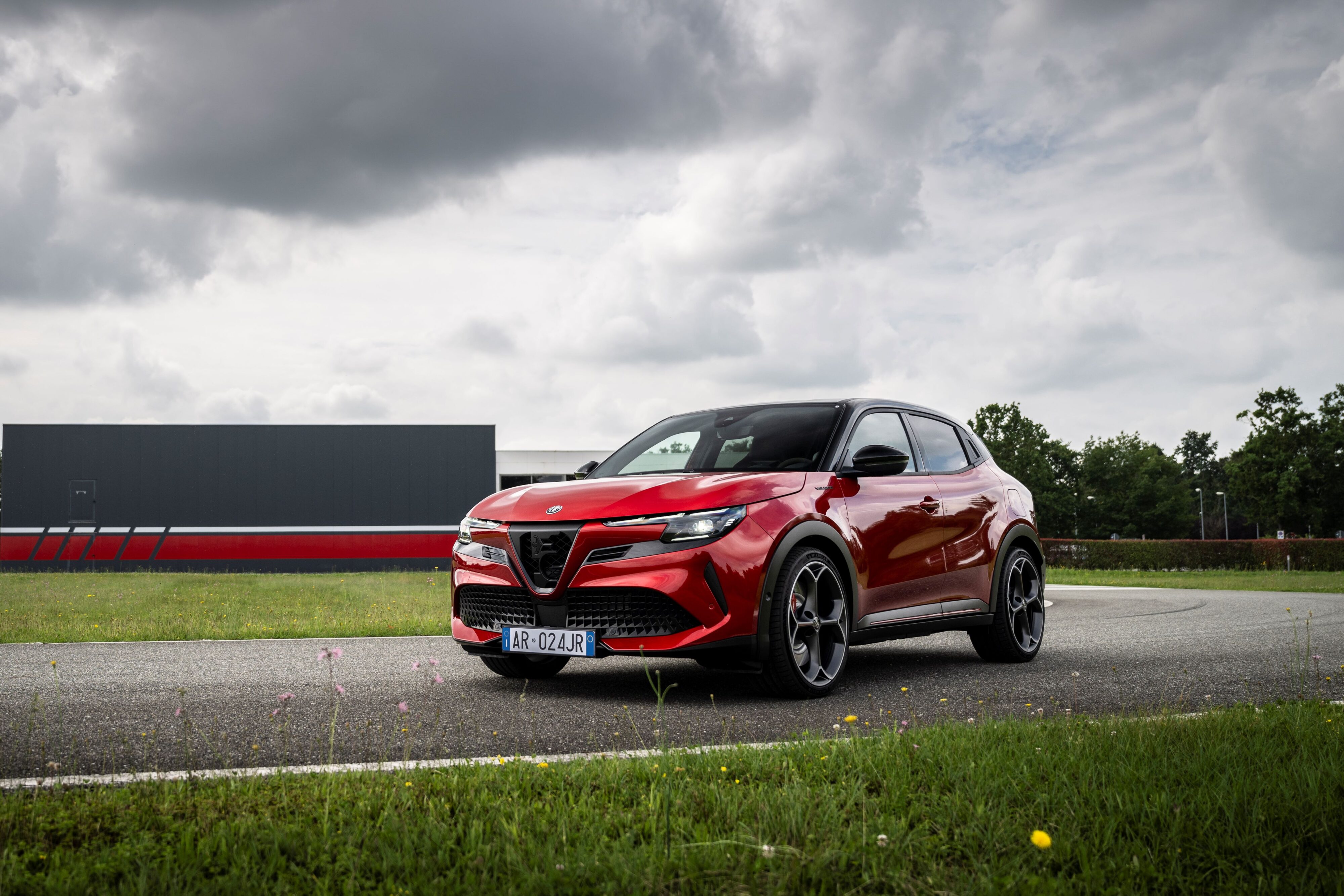 Front three quarters view of a 2025 Alfa Romeo Junior in Red.