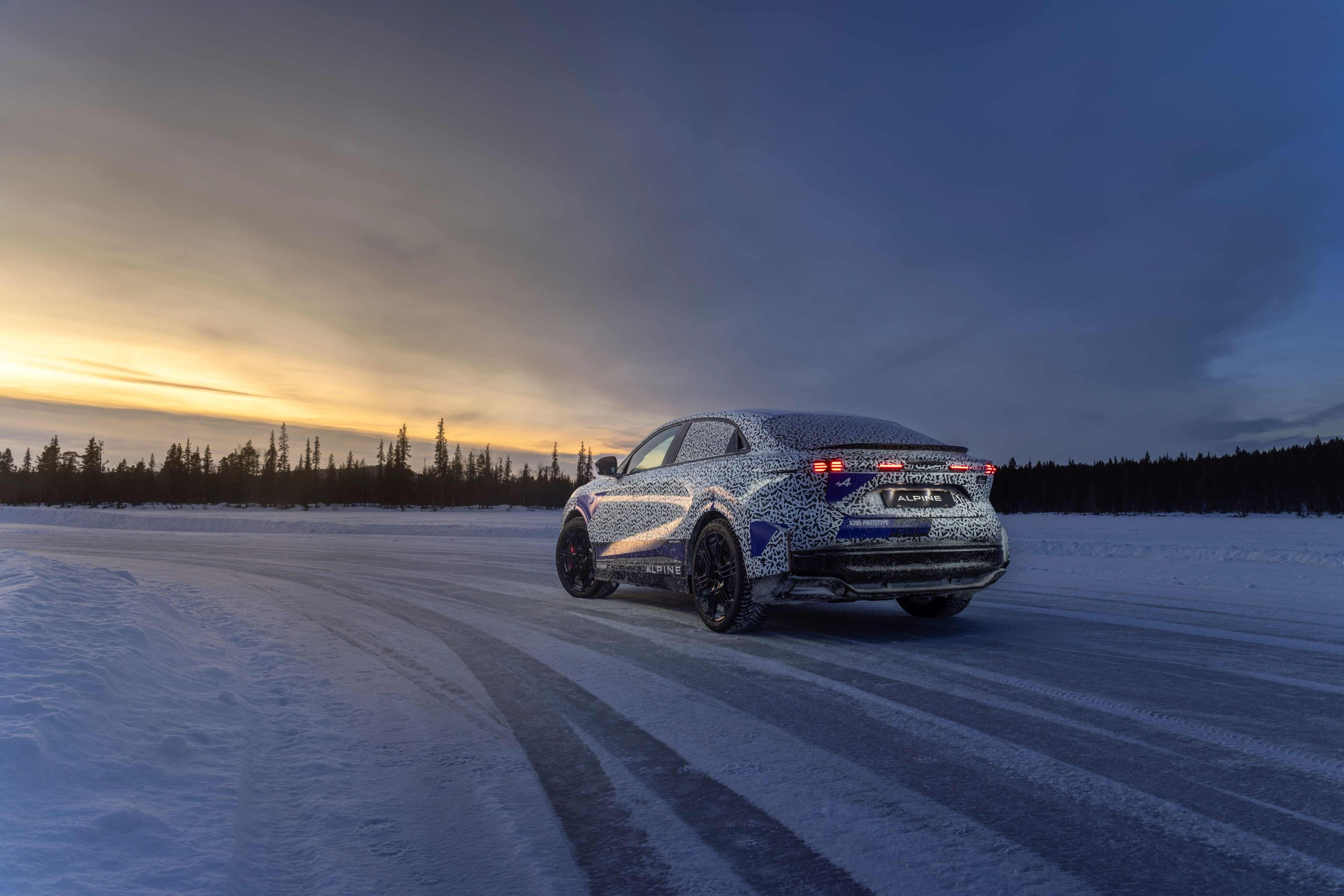 Rear three quarters view of an Alpine A390 under camouflage, testing in the Arctic Circle.