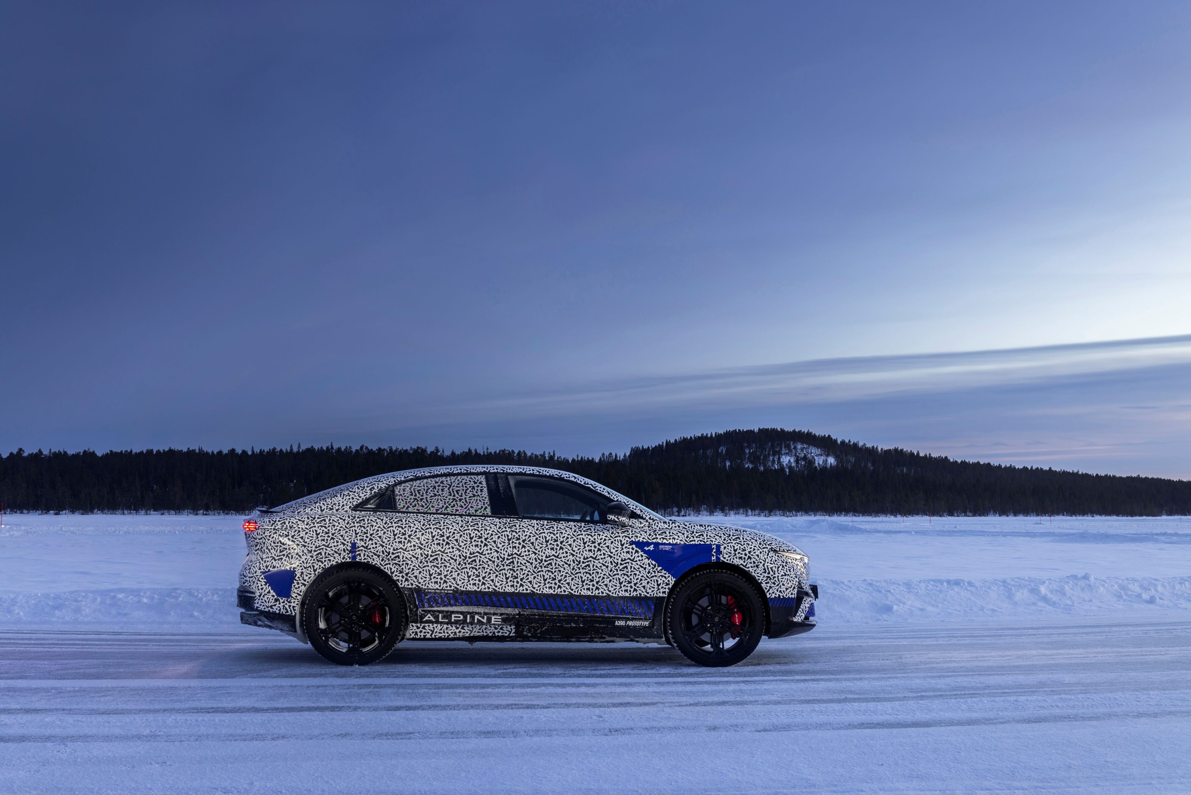 Side on view of an Alpine A390 under camouflage, testing in the Arctic Circle.