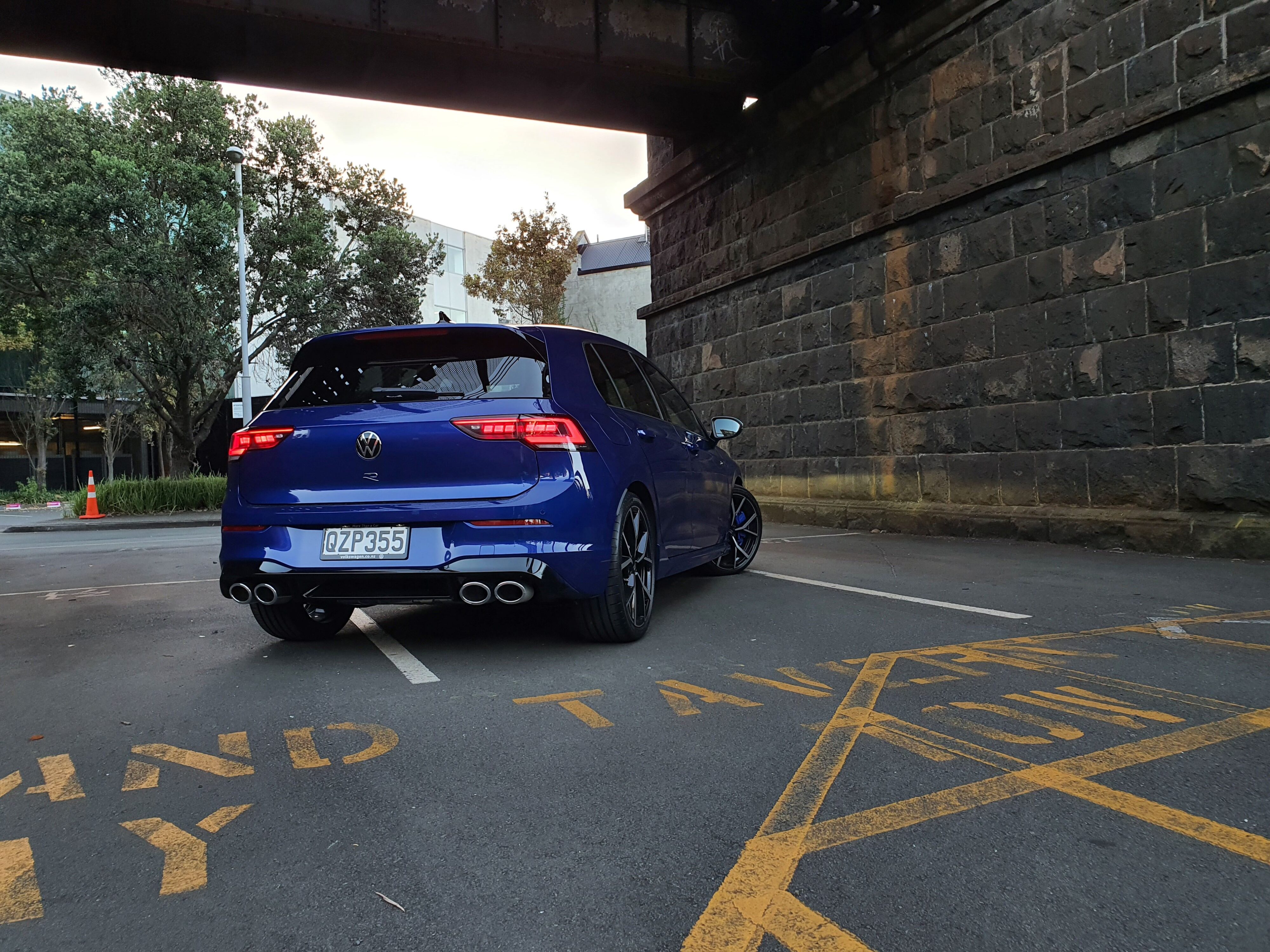 Rear three quarters view of a 2025 Volkswagen Golf R Mk8.5 in Lapiz Blue Metallic.